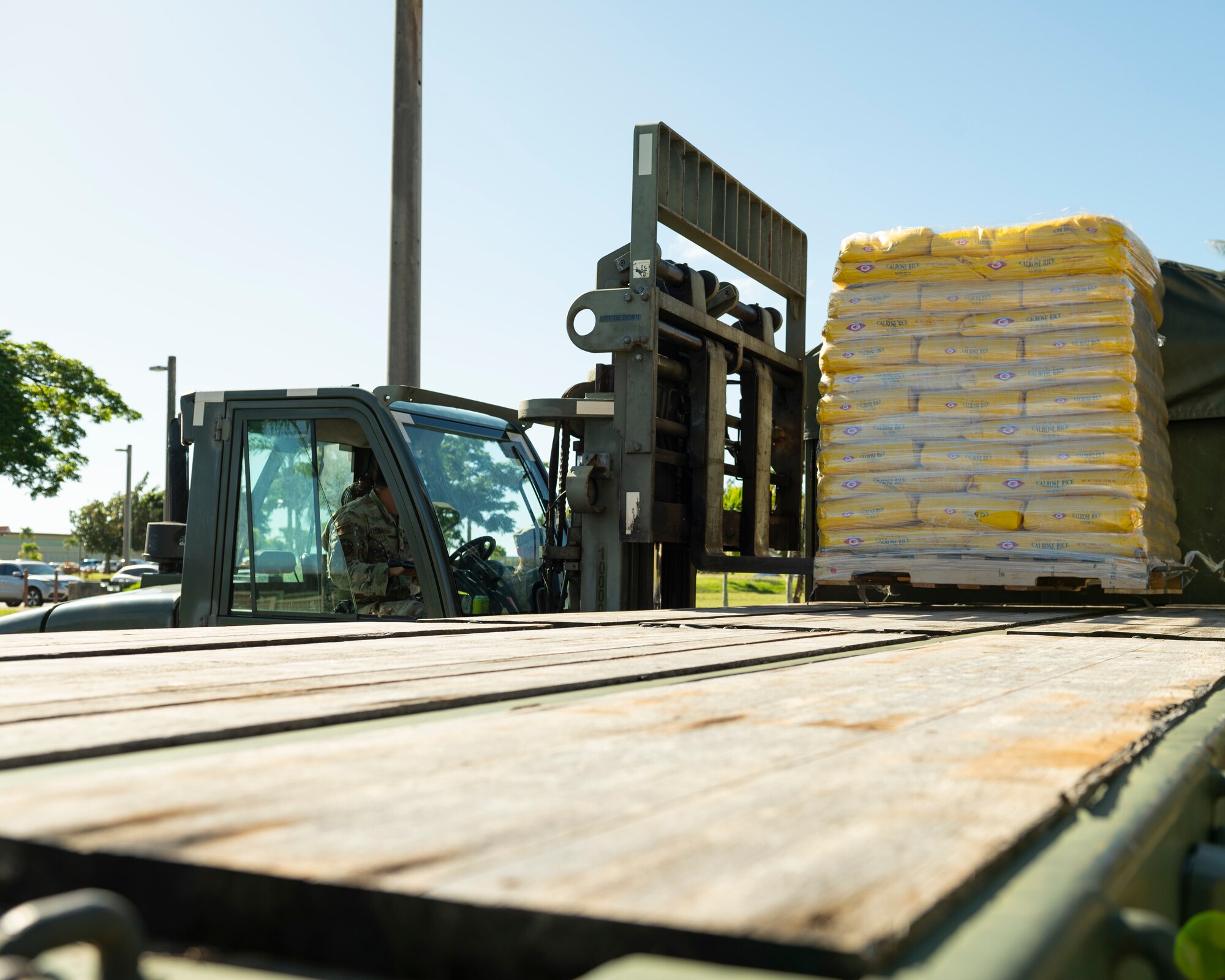 U.S. Air Force Tech. Sgt. Charles Hall, noncommissioned officer in charge of ground transportation training assigned to the 36th Logistics Readiness Squadron, uses a 10K 463L forklift to move pallets of rice on Andersen Air Force Base, Guam, Dec. 1, 2022. Members of the ground transportation team moved about 50,000 pounds of cargo in support of the 71st Operation Christmas Drop. (U.S. Air Force photo by Airman Spencer Perkins)