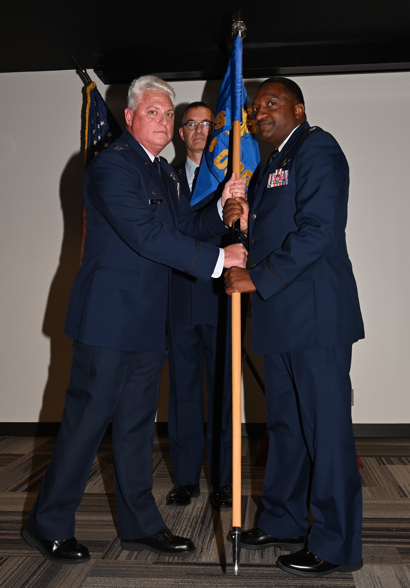 a man hands another man a flag