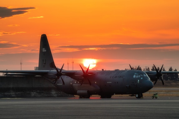 The sun rises over the 374th Airlift Wing's C-130J Super Hercules aircraft