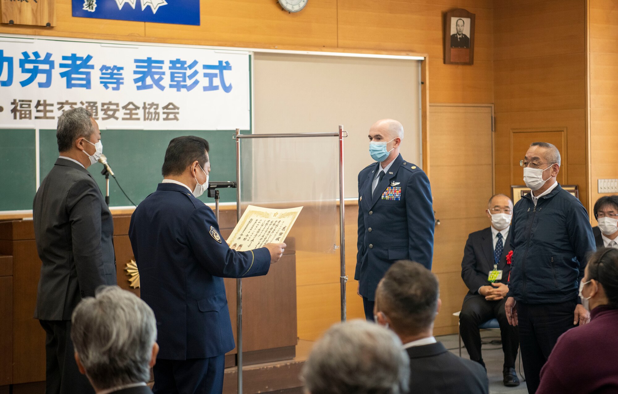 Someone reads the safety award to a crowd before presenting the award to the recipient.