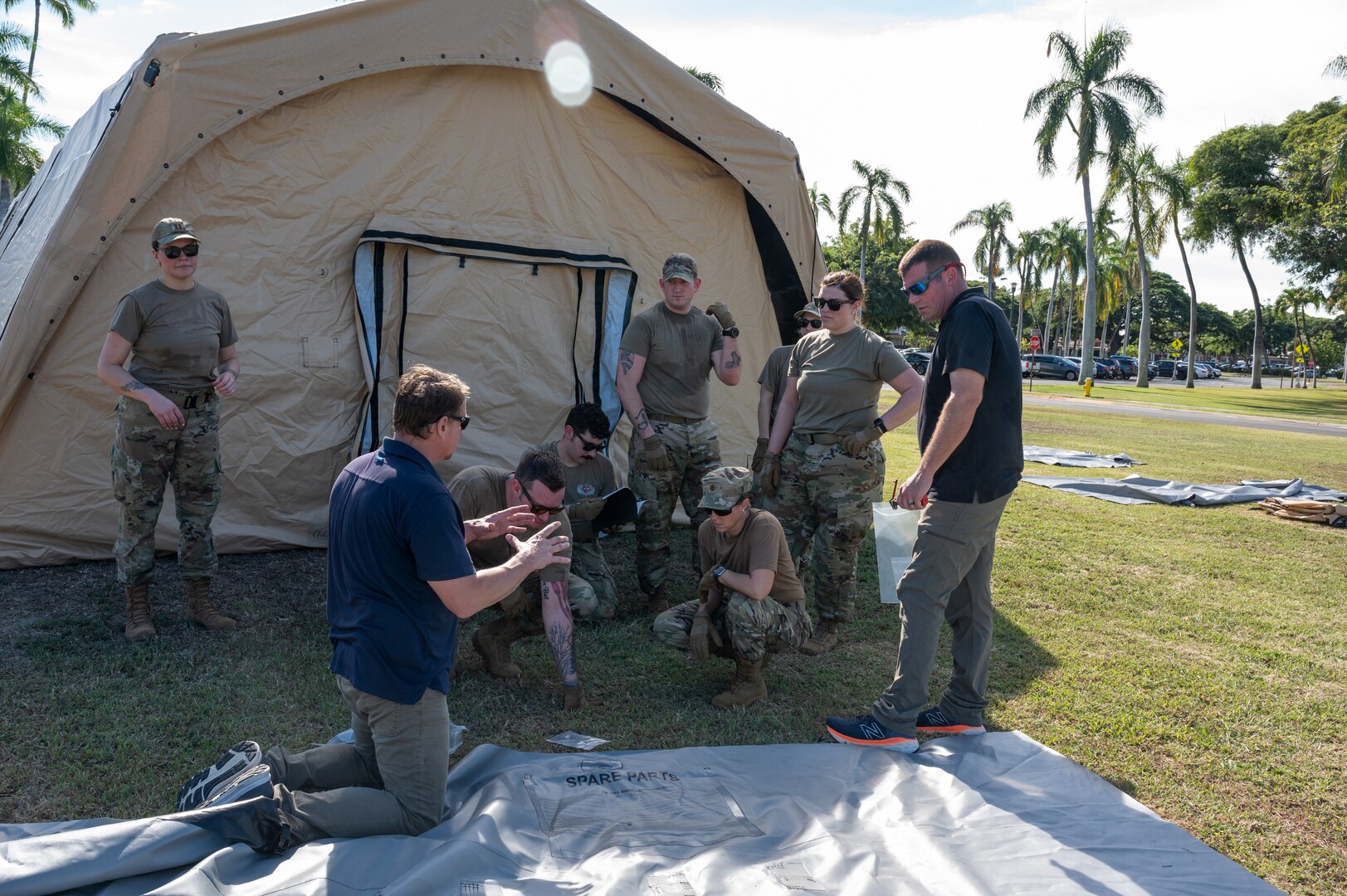 Photo of Airmen from the Alaska Air National Guard and contractors setting up a Tactical Shelter.