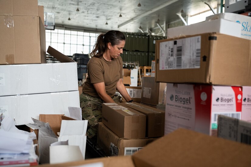 Photo of Airmen from the Alaska Air National Guard and contractors setting up a Tactical Shelter.