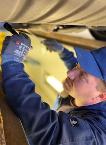 Tobias Mayer inspects a privately owned vehicle at the Baumholder POV inspection station, Dec. 8. Mayer is a mobile heavy equipment mechanic and inspector at the 405th Army Field Support Brigade’s Base Support Operations Maintenance, but he also fills in at the POV inspection station when his co-workers are unavailable.