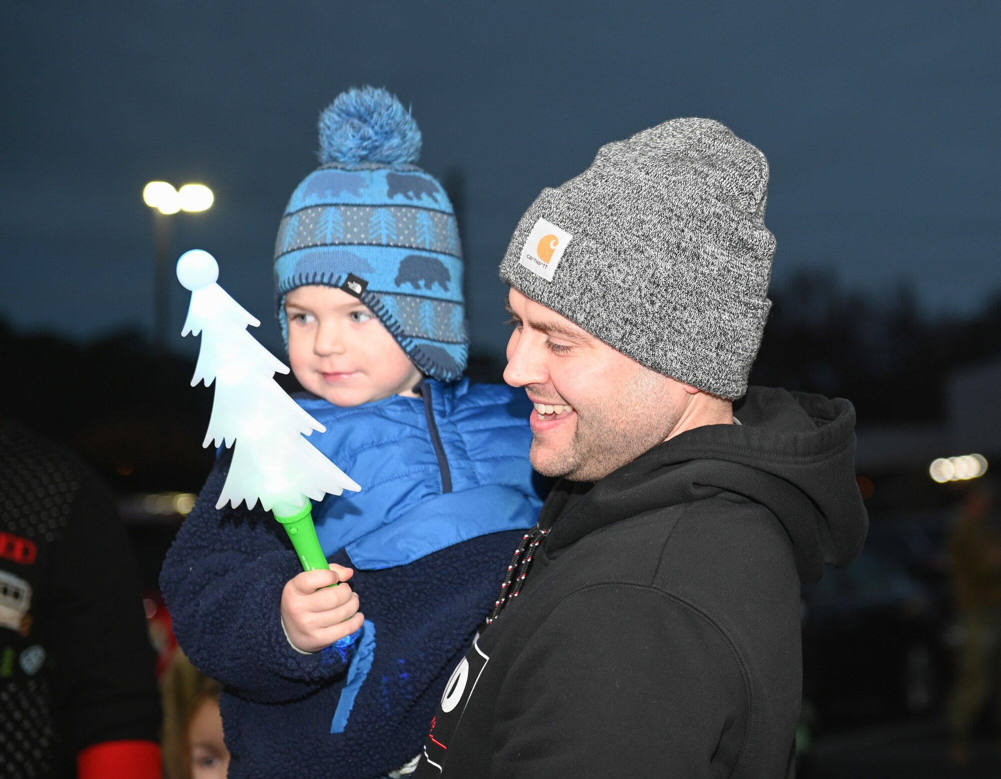 A father and son enjoy the festivities during the Holiday Village and vendor fair at Seymour Johnson Air Force Base, North Carolina, Dec. 5, 2022. The event included entertainment for children, music performances, Santa and Mrs. Claus and vendor booths. (U.S. Air Force photo by Airman 1st Class Rebecca Sirimarco-Lang)