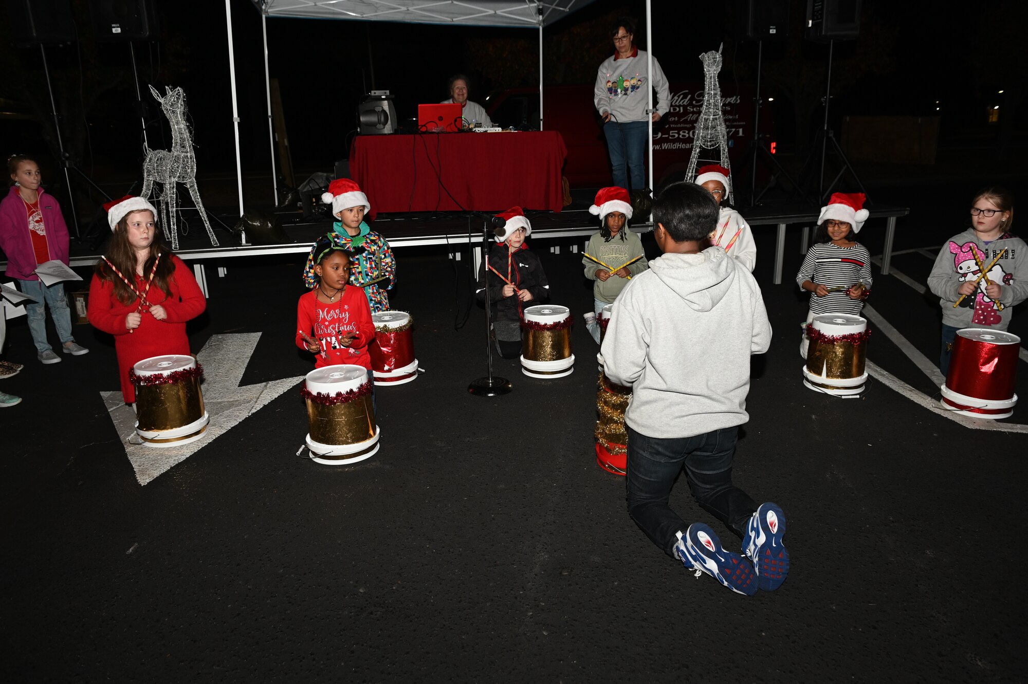 Children from the Seymour Johnson Air Force Base Youth Center play drums at the Holiday Village and vendor fair at Seymour Johnson AFB, North Carolina, Dec. 5, 2022. The tree lighting ceremony brought Airmen and their families together on base to celebrate the holidays. (U.S. Air Force photo by Airman 1st Class Rebecca Sirimarco-Lang)