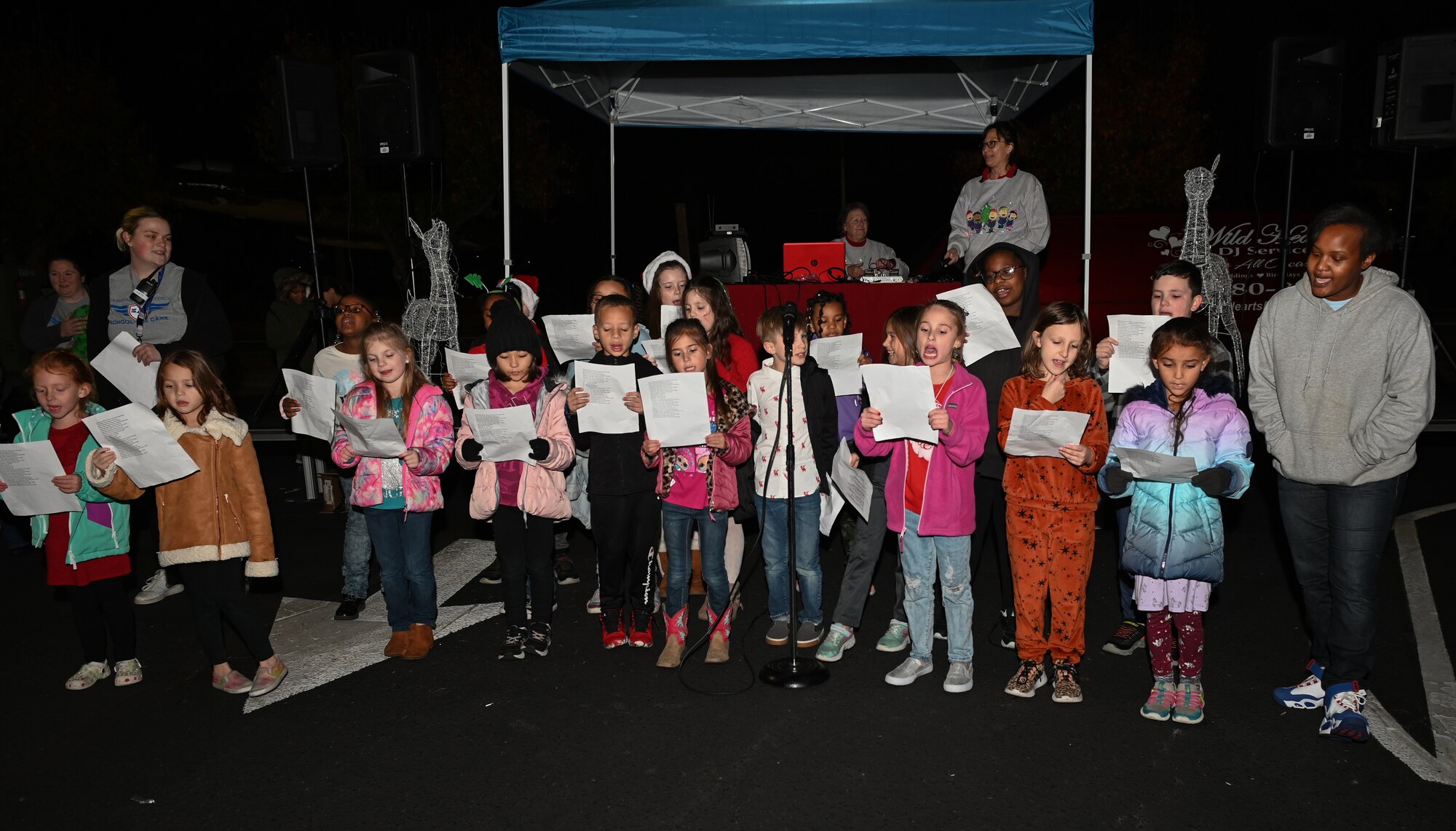 Children from the Seymour Johnson Air Force Base Youth Center sing Christmas carols during the Holiday Village and vendor fair at Seymour Johnson Air Force Base, North Carolina, Dec. 5, 2022. The celebration is hosted at the beginning of December each year for U.S. service members and their families to welcome the holiday season. (U.S. Air Force photo by Airman 1st Class Rebecca Sirimarco-Lang)