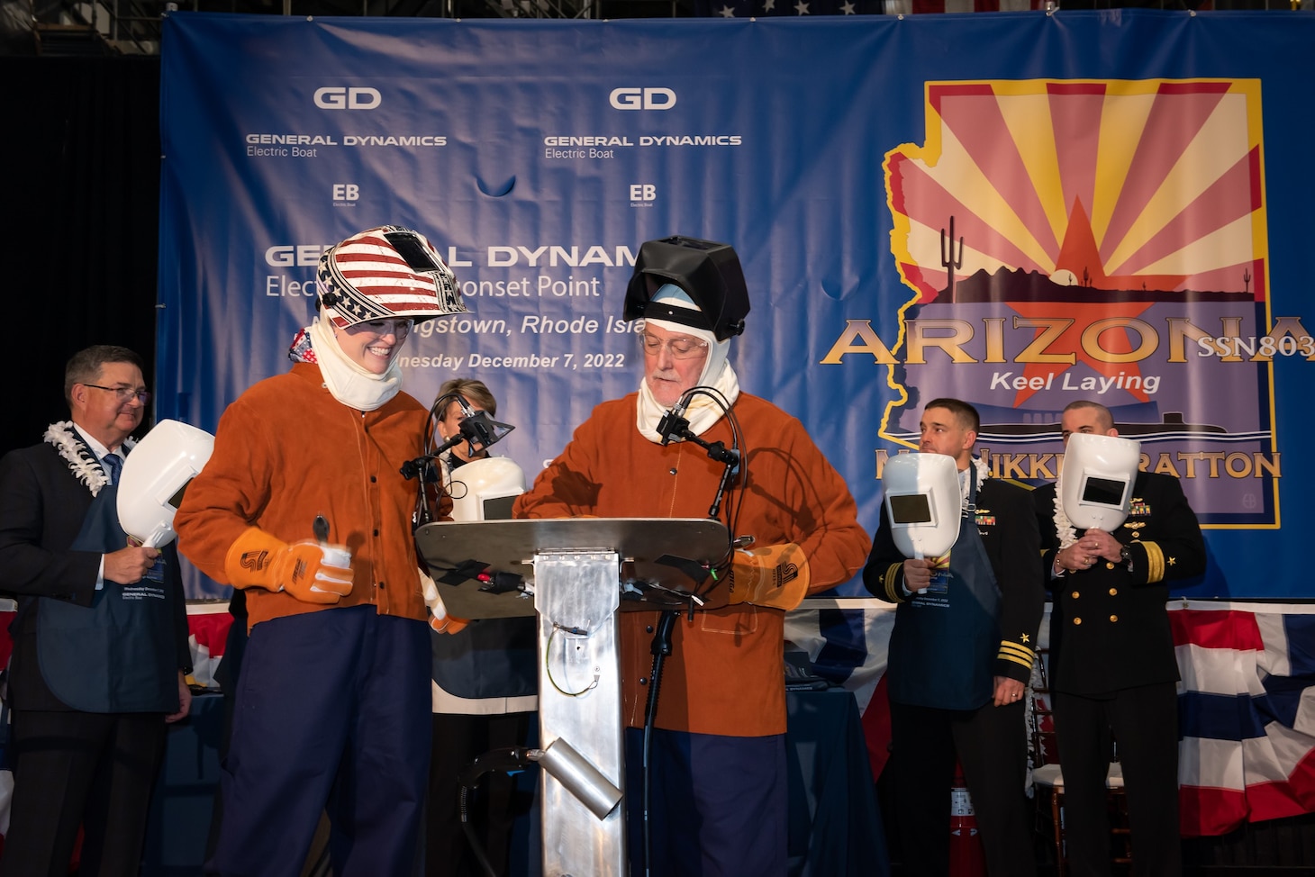 Ship Sponsor Nikki Stratton (left foreground) and Electric Boat welder Bob Hobday prepare to weld Stratton's initials into a plate
that will be placed on the future USS Arizona (SSN 803), during the boat's keel authentication ceremony at the Electric Boat Quonset Point Facility in North Kingstown, R.I., Dec. 7.