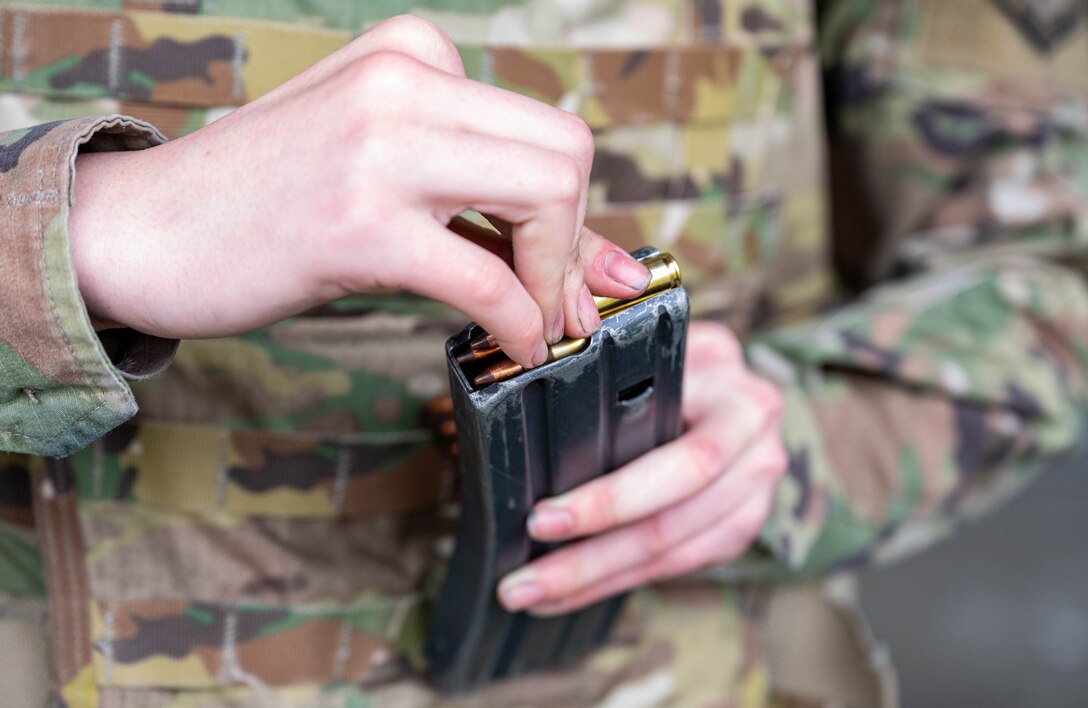 U.S. Air Force Airman 1st Class Adam Fewox, 633d Operational Medical Readiness Squadron medical technician, loads 10 rounds into his M-4 carbine rifle magazine in preparation for the live-firing test during a Combat Arms Training and Maintenance qualification course at Joint Base Langley-Eustis, Virginia, Nov. 30, 2022.