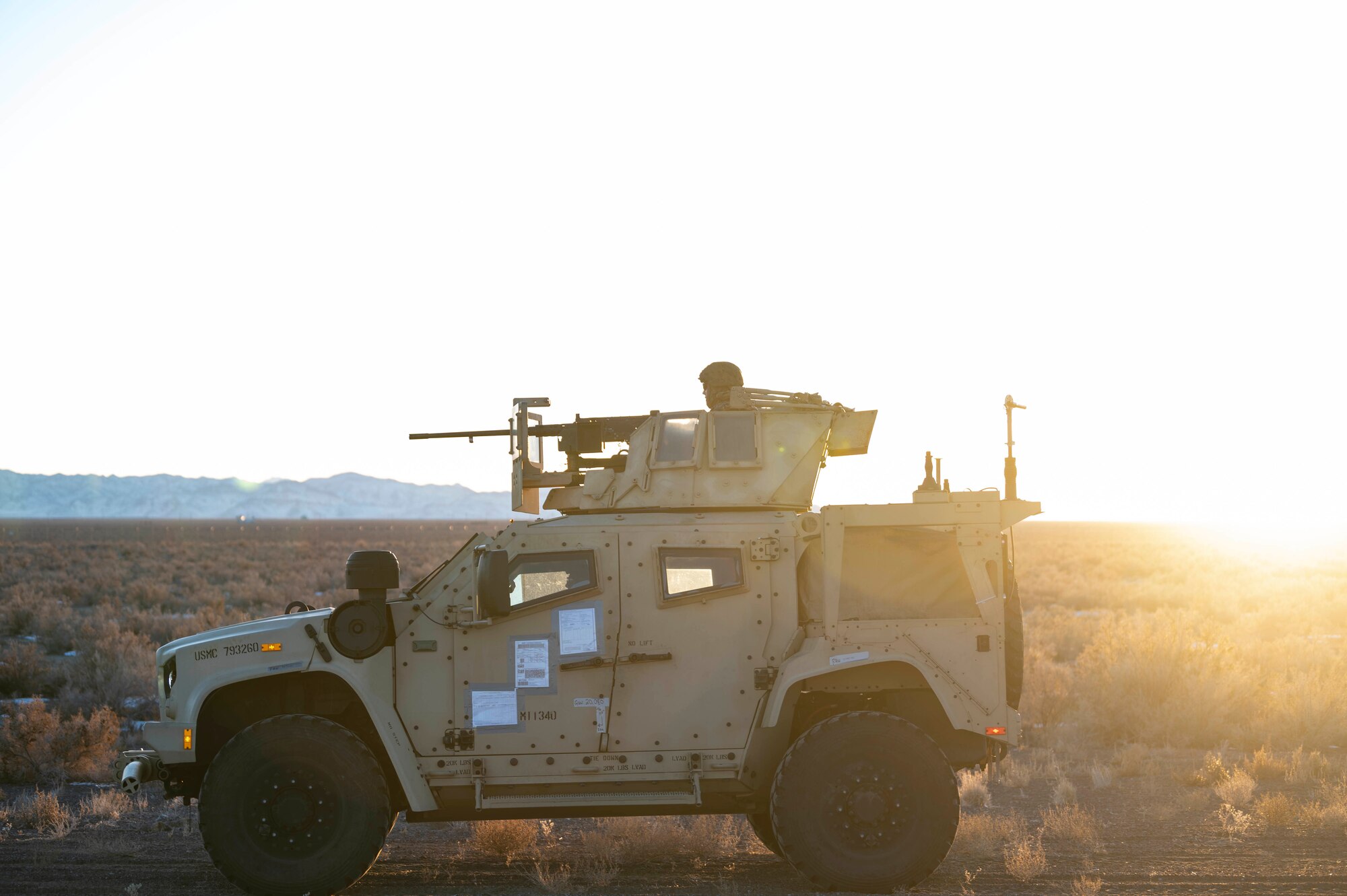 Man sits on top of a military vehicle