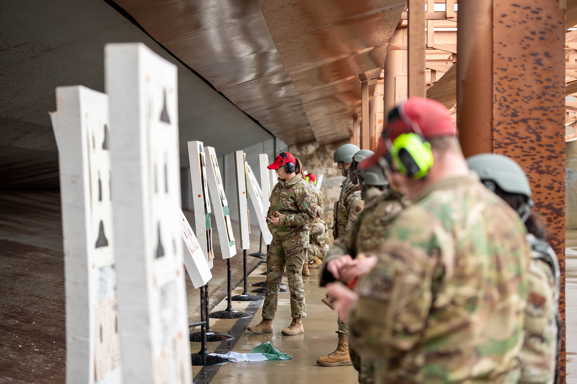 U.S. Air Force Senior Airman Rachel Valdez ,633d Security Forces Squadron combat arms instructor, grades an Airman’s shot accuracy during a Combat Arms Training and Maintenance qualification course at Joint Base Langley-Eustis, Virginia, Nov. 30, 2022.