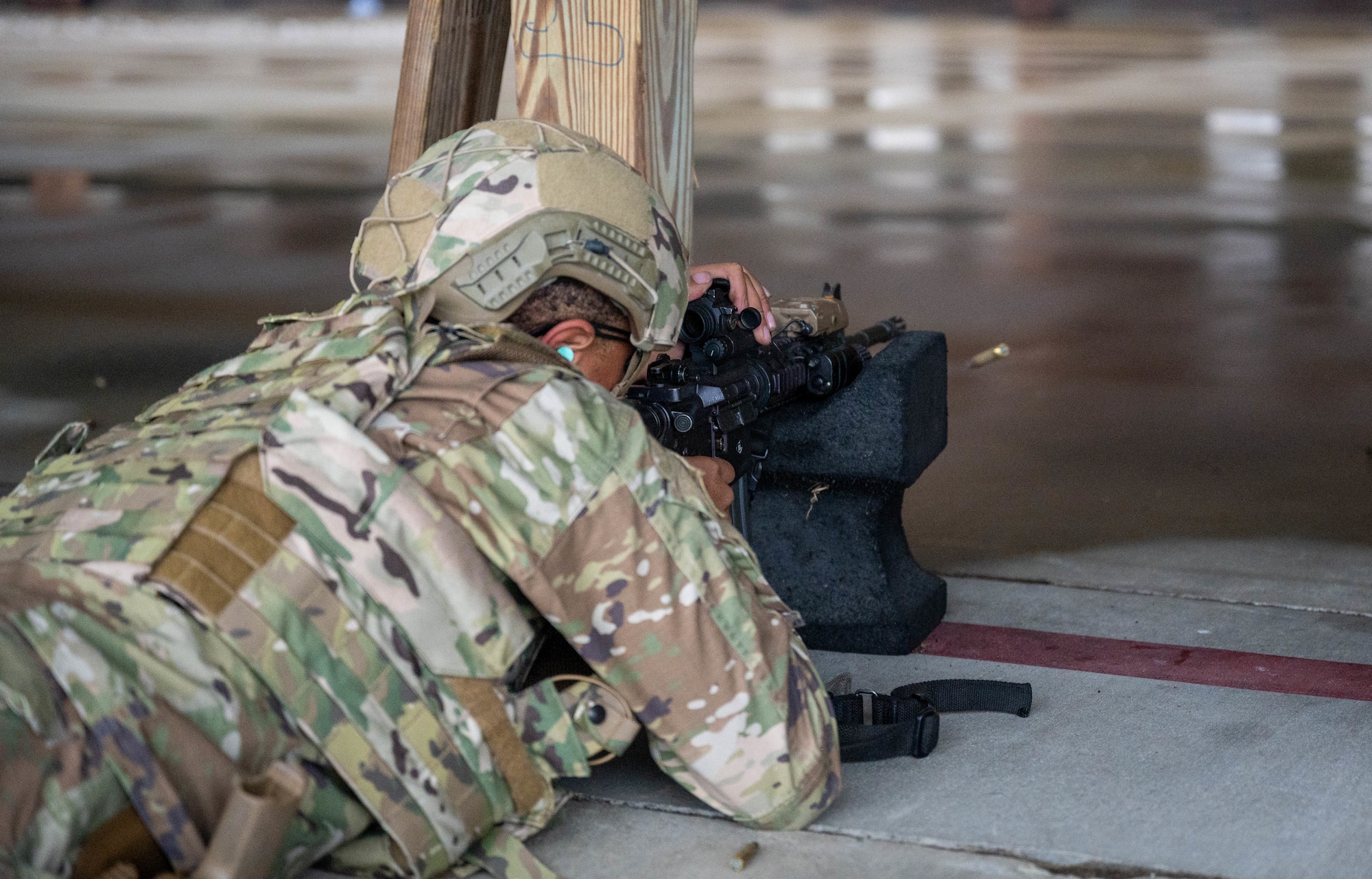 U.S. Air Force 633d Security Forces Squadron Defender shoots his M-4 carbine rifle for his annual weapons qualification testing during a Combat Arms Training and Maintenance qualification course at Joint Base Langley-Eustis, Virginia, Nov. 30, 2022.