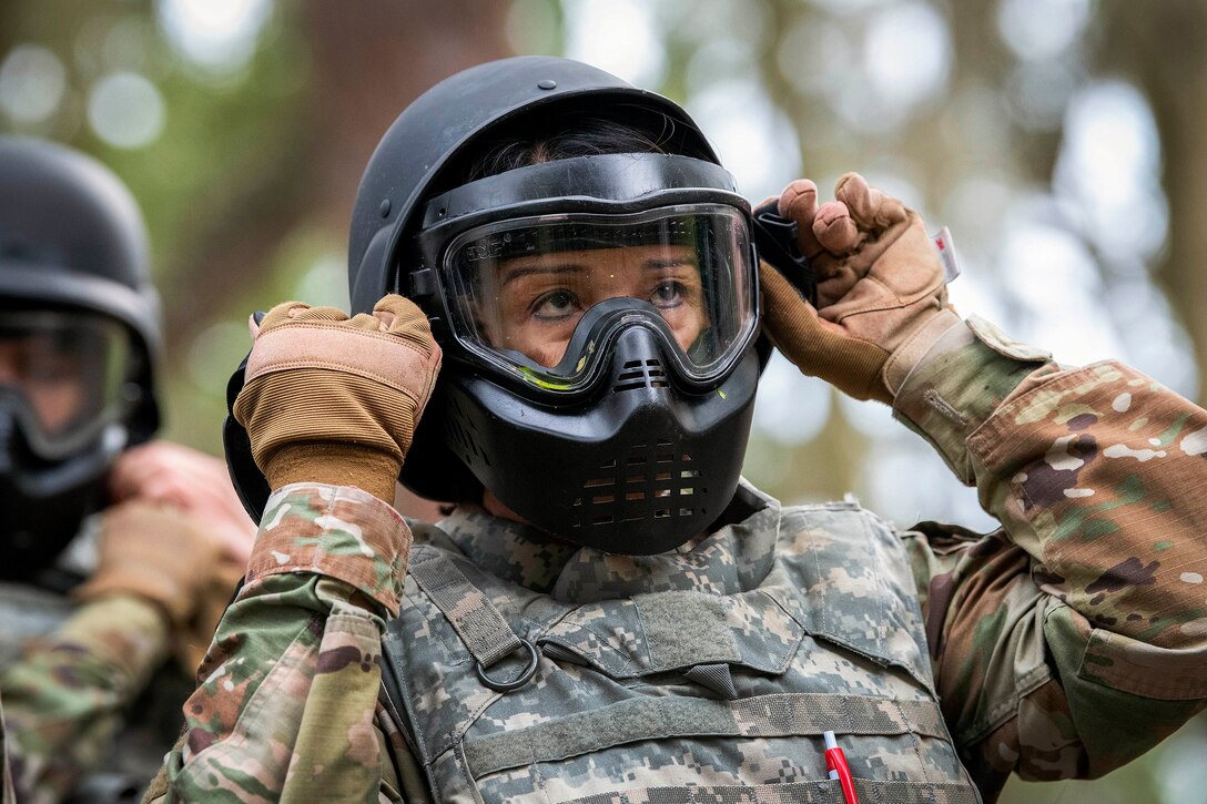 An airman puts on a protective mask before training.