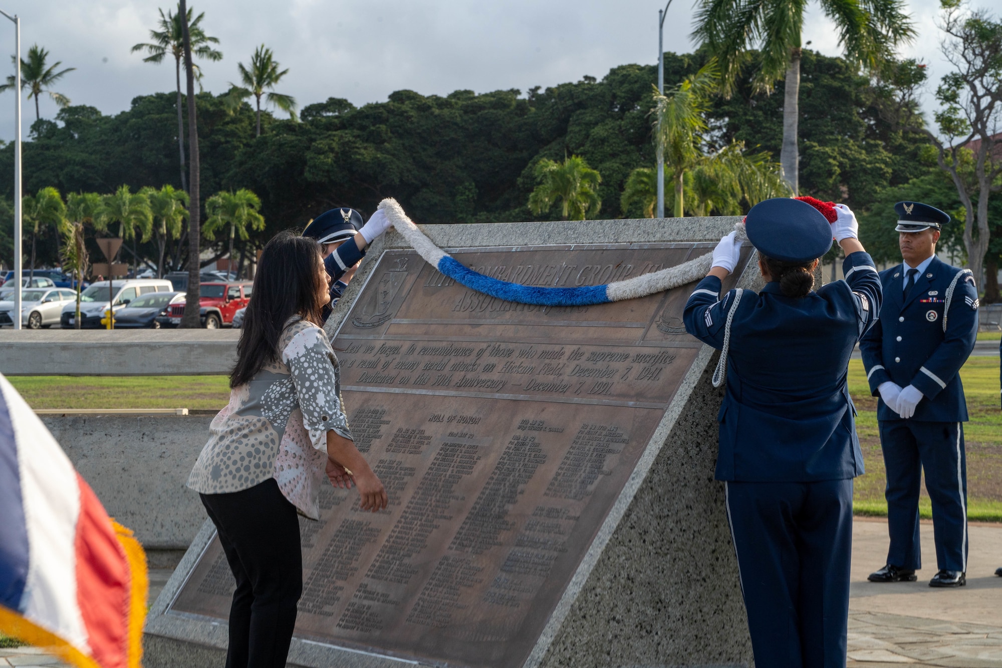 Mrs. Jessie Higa, Volunteer Historian and members from the 15th Wing’s Base Honor Guard place a lei on a memorial during the 81st Remembrance Ceremony at Joint Base Pearl Harbor-Hickam, Hawaii, Dec. 7, 2022.  The annual remembrance ceremony is held at the same location as the attacks in 1941 to honor and commemorate those affected by the aerial attack. (U.S. Air Force photo by Senior Airman Makensie Cooper)