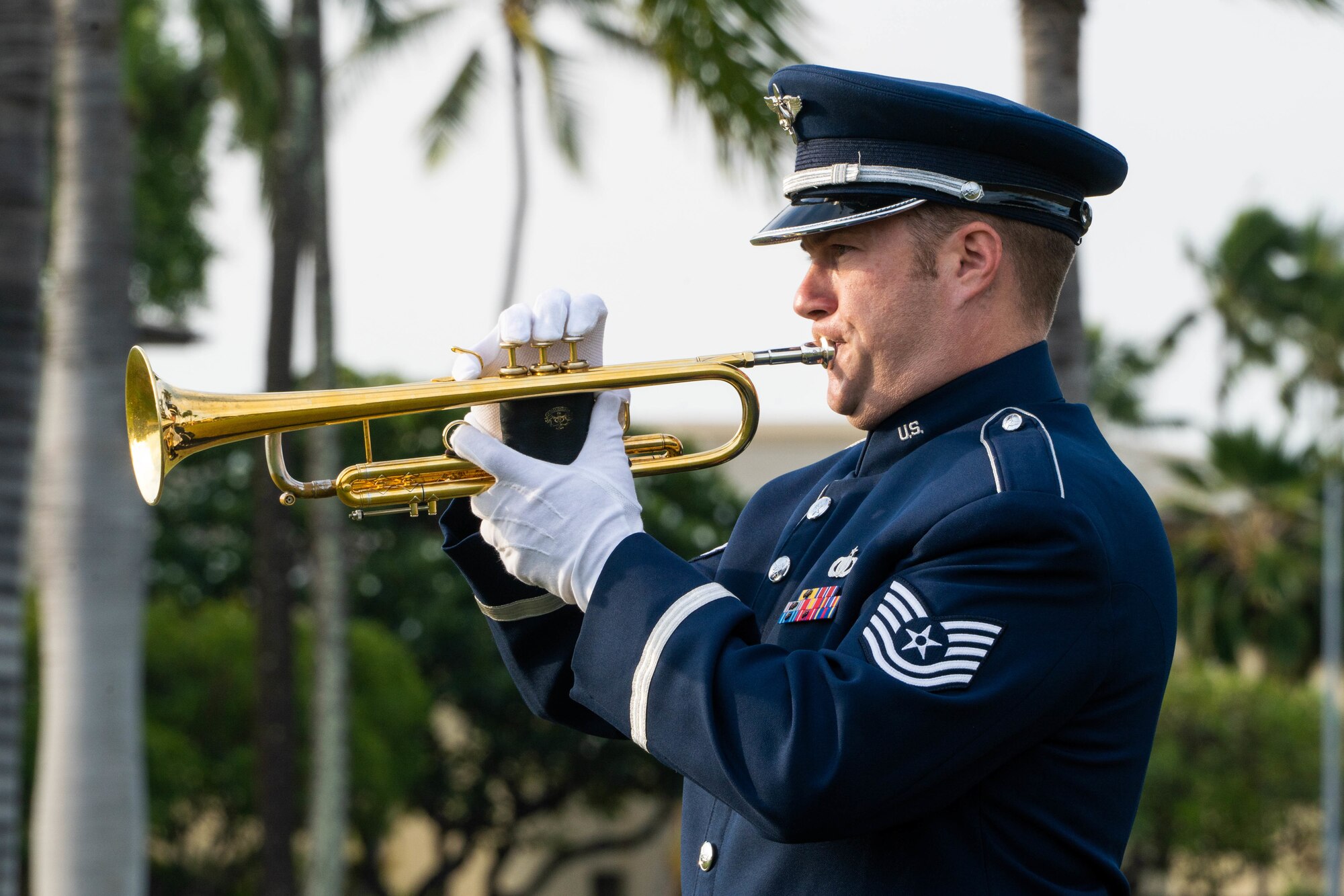 Tech Sgt. Nicholas Ciardelli, Band of the Pacific, regional band craftsman, trumpet, plays Taps during the December 7th Remembrance Ceremony at Joint Base Pearl Harbor-Hickam, Hawaii, Dec. 7, 2022.  Service members past and present, friends and family came together to remember the 81st anniversary of the attacks on Hickam Field and to honor the 189 service members that died and 303 wounded. (U.S. Air Force photo by Senior Airman Makensie Cooper)