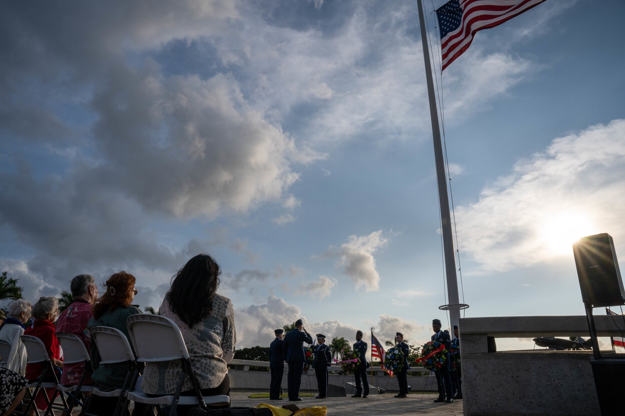 Hickam Airmen present a wreath at the December 7 Remembrance Ceremony at Joint Base Pearl Harbor-Hickam, Hawaii, Dec. 7, 2022. The annual remembrance ceremony honored and reflected those who were affected by the attacks around the island of Oahu. (U.S. Air Force photo by Senior Airman Makensie Cooper)