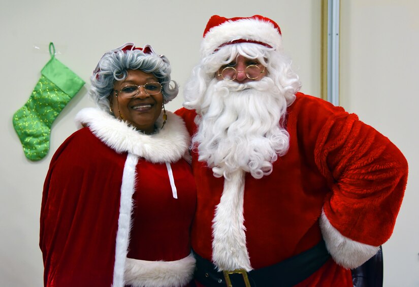 Mr. and Mrs. Claus pose for a picture.