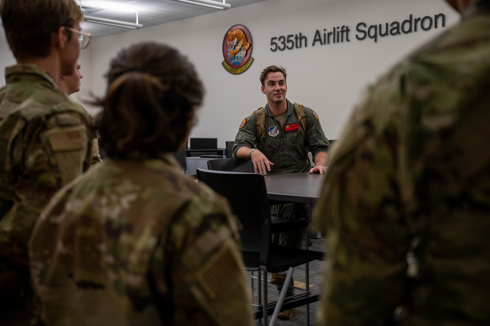 U.S Air Force Staff Sgt. Gethyn Berner, 535th Airlift Squadron loadmaster gives a squadron tour to Air Force ROTC Cadets from the University of Hawaii Manoa at Joint Base Pearl Harbor-Hickam, Hawaii, Dec. 5, 2022. The cadets were given the opportunity to meet with Hickam Airmen, tour the 535th Airlift Squadron and fly on a C-17 Globemaster III. (U.S. Air Force photo by Senior Airman Makensie Cooper)