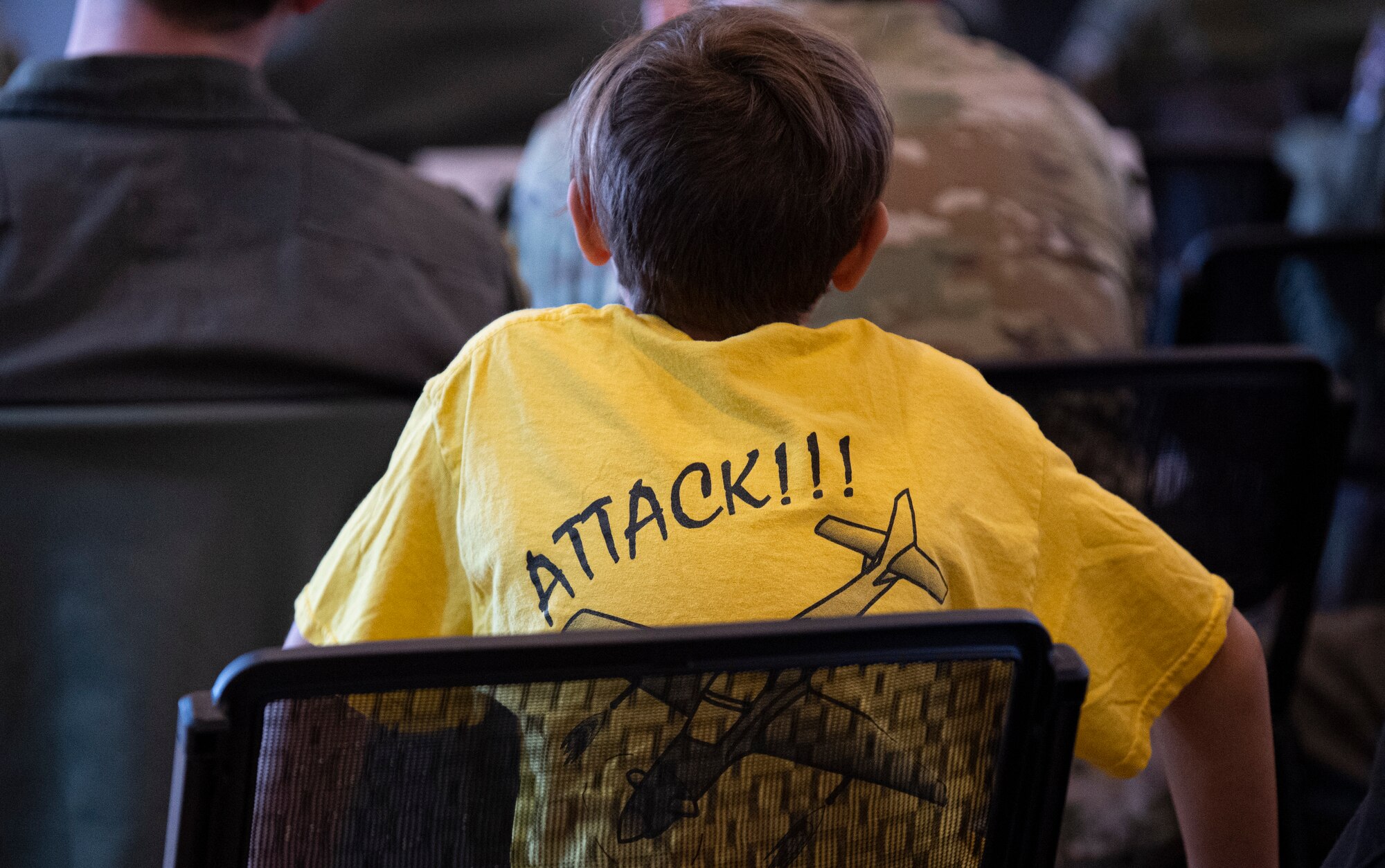 Members of the 81st Fighter Squadron gather with their friends and families at Moody Air Force Base, Georgia, Dec. 5, 2022, in honor of the deactivation ceremony for their squadron. Children in attendance of the ceremony wore shirts that read the 81st FS motto, “ATTACK!” ” (U.S. Air Force photo by Airman 1st Class Whitney Gillespie)