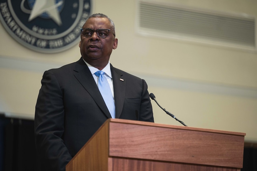 Secretary of Defense Lloyd J. Austin III speaks at a lectern.