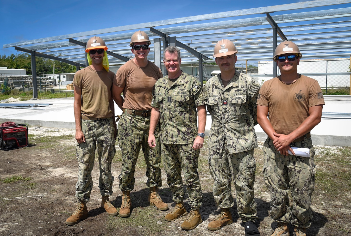 Adm. Samuel Paparo poses for a photo with Seabees assigned to Naval Mobile Construction Battalion (NMCB) 4.