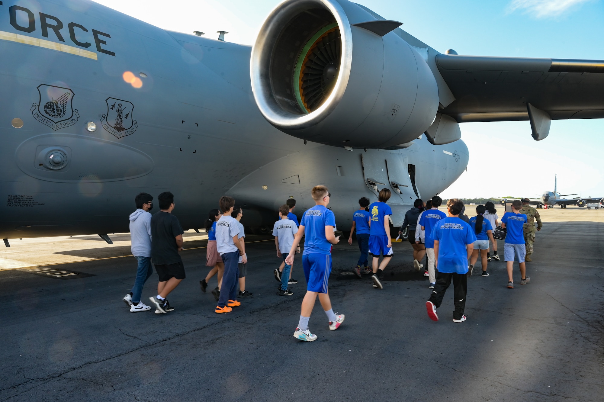 Students from Aliamanu Middle School tour a C-17 Globemaster III at Joint Base Pearl Harbor-Hickam, Hawaii, Nov. 22, 2022. Active duty and Hawaii Air National Guard members highlighted their mission operations and capabilities during the showing of a C-17 static and F-22 Raptor static. (U.S. Air Force photo by Staff Sgt. Alan Ricker)