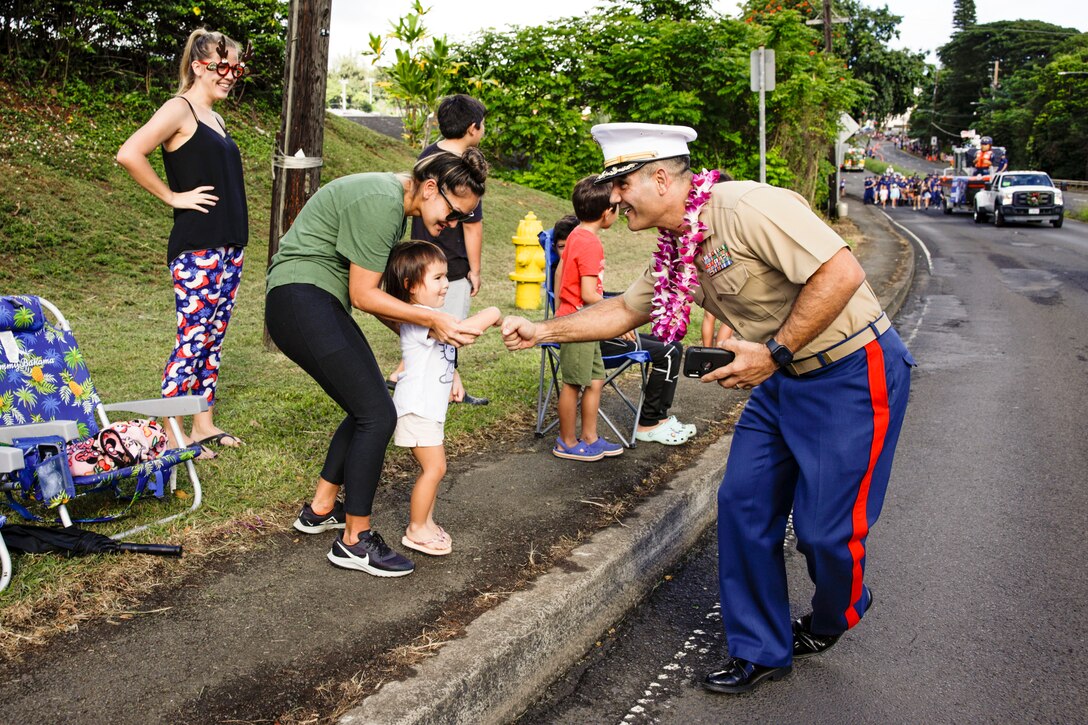 U.S. Marine Corps Col. Speros Koumparakis, commanding officer, Marine Corps Base Hawaii, greets spectators during the Kaneohe Holiday Parade, Kaneohe, Hawaii, Dec. 3, 2022. Base leadership participated in the event in order to commence the start of the holiday season and strengthen relationships between MCBH and the local community. (U.S. Marine Corps photo by Cpl. Samantha Sanchez)