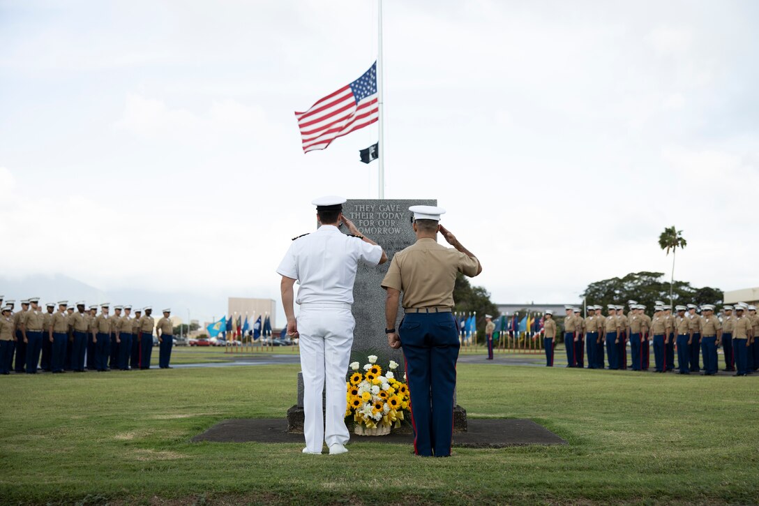 U.S. Marine Corps Col. Speros C. Koumparakis, commander, Marine Corps Base Hawaii and U.S. Navy Cmdr. Stephen Niemann, officer in charge, Naval Support Detachment, salute the Klipper Memorial during the 2022 Klipper Ceremony, MCBH, Dec. 7, 2022. The Klipper Memorial was dedicated in 1981 to honor the 17 U.S. Navy Sailors and two civilian contractors who died during the attack on Naval Air Station Kaneohe Bay on Dec. 7, 1941. (U.S. Marine Corps photo by Staff Sgt. Jordan E. Gilbert)