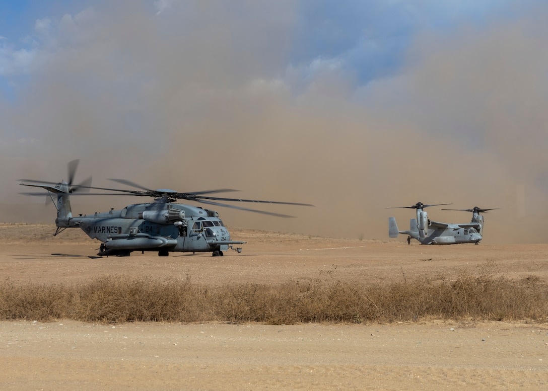 MARINE CORPS BASE CAMP PENDLETON, California (Sept. 2, 2022) – U.S. Marine Corps pilots with Marine Medium Tiltrotor Squadron (VMM) 362 (Reinforced), 13th Marine Expeditionary Unit, land a CH-53E Super Stallion, left, and a MV-22B Osprey during an Evacuation Control Center exercise. A force in readiness, the 13th MEU trains to rapidly respond to crises across all domains. Marines and Sailors of the 13th MEU are embarked aboard the Makin Island Amphibious Ready Group (ARG) conducting integrated training operations in U.S. 3rd Fleet. (U.S. Marine Corps photo by Sgt. Kevin G. Rivas)