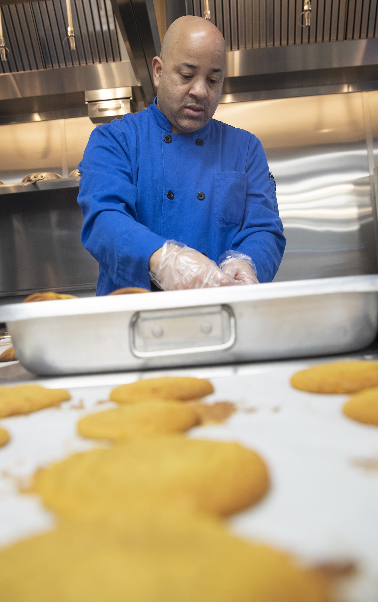 Barry Oxendine, Yokota High School culinary arts teacher, sort cookies onto trays in preparation for the base’s annual Yokota Cookie Crunch at the Yokota High School located at Yokota Air Base, Japan, Dec. 8, 2022. Hosted by the Enlisted Spouses Club, the Team Yokota Cookie Crunch originated in 2005 as a way for members of Yokota to deliver homemade sweets to unaccompanied service members residing in the dorms while living away from home. (U.S. Air Force photo by Tech. Sgt. Christopher Hubenthal)