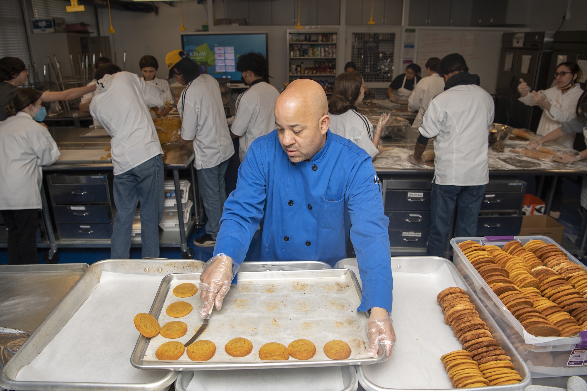 Barry Oxendine, Yokota High School culinary arts teacher, instructs his student how to bake cookies in preparation for the base’s annual Yokota Cookie Crunch at the Yokota High School located at Yokota Air Base, Japan, Dec. 8, 2022. Hosted by the Enlisted Spouses Club, the Team Yokota Cookie Crunch originated in 2005 as a way for members of Yokota to deliver homemade sweets to unaccompanied service members residing in the dorms while living away from home.  (U.S. Air Force photo by Tech. Sgt. Christopher Hubenthal)