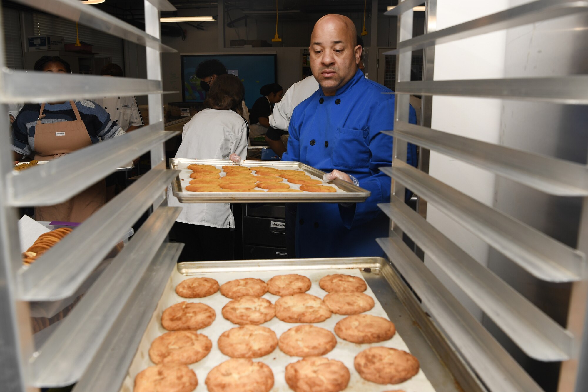 Barry Oxendine, Yokota High School culinary arts teacher, organizes cookie trays in preparation for the base’s annual Yokota Cookie Crunch at the Yokota High School located at Yokota Air Base, Japan, Dec. 8, 2022. Oxendine retired after serving twenty-one years as a culinary specialist in the National Guard and uses his knowledge and passion for cooking to teach his students. (U.S. Air Force photo by Tech. Sgt. Christopher Hubenthal)