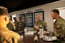 U.S. Air Force Chief Master Sgt. Robert Schultz, Air Force Sustainment Center command chief chats with Airmen from the 635th Materiel Maintenance Group at Holloman Air Force Base, New Mexico, Dec. 6, 2022. The 635th MMG consists of a highly-trained diverse group of Airmen who provide mission-ready equipment for future deployments. (U.S. Air Force photo by Airman 1st Class Isaiah Pedrazzini)