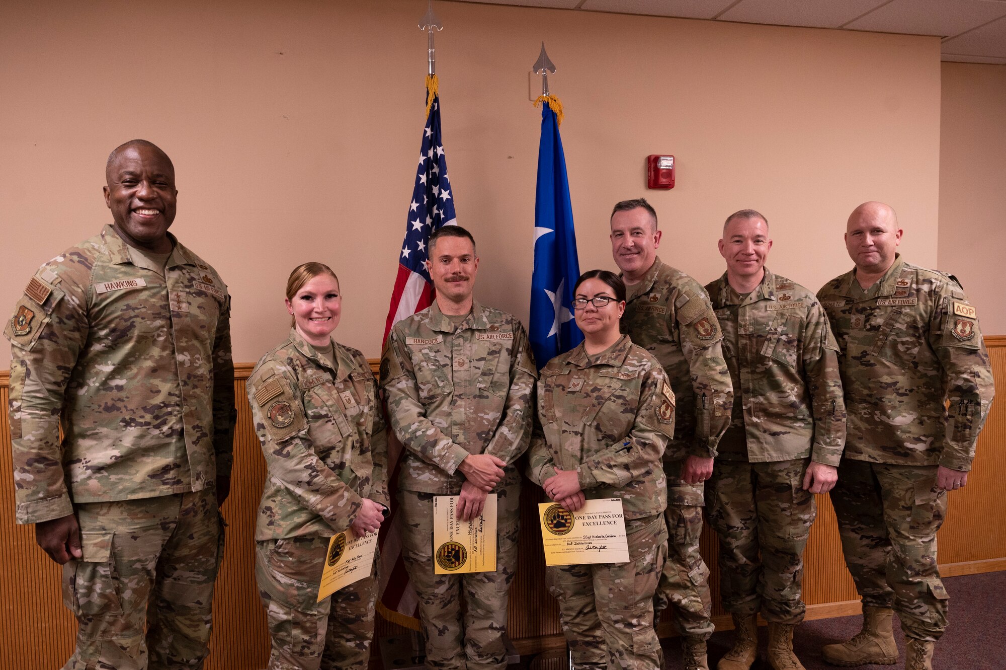 Airmen from the 635th Materiel Maintenance Group, pose for a photo with U.S. Air Force Lt. Gen. Stacey Hawkins, Air Force Sustainment Center commander, left, and U.S. Air Force Chief Master Sgt. Robert Schultz, Air Force Sustainment Center command chief, right, at Holloman Air Force Base, New Mexico, Dec. 6, 2022. Three of the Airmen received a certificate and a coin for embracing the Art of Possible, a management system that creates an environment of success for problem-solvers. (U.S. Air Force photo by Airman 1st Class Isaiah Pedrazzini