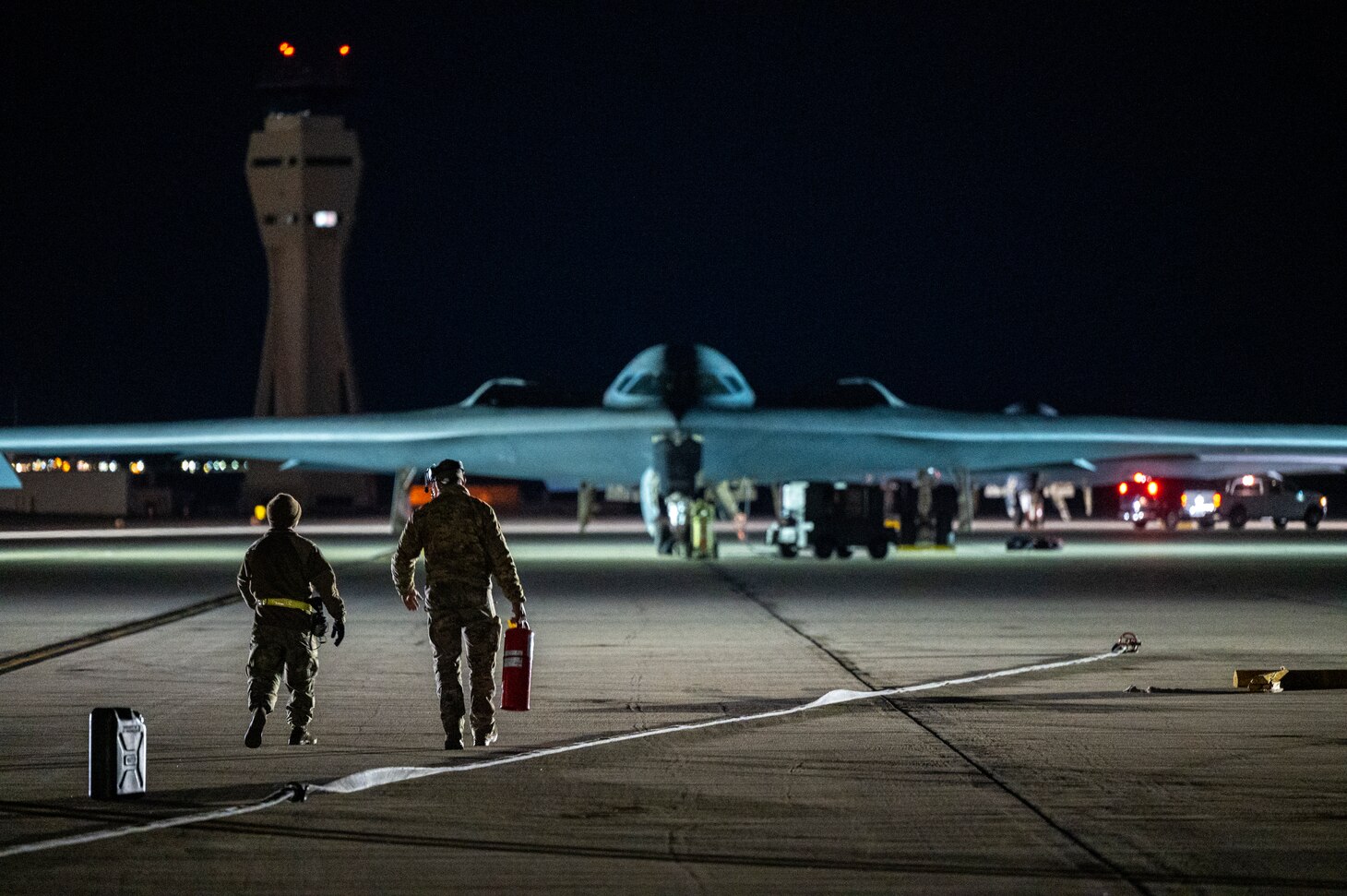 Airmen walking towards B-2 Spirit plane