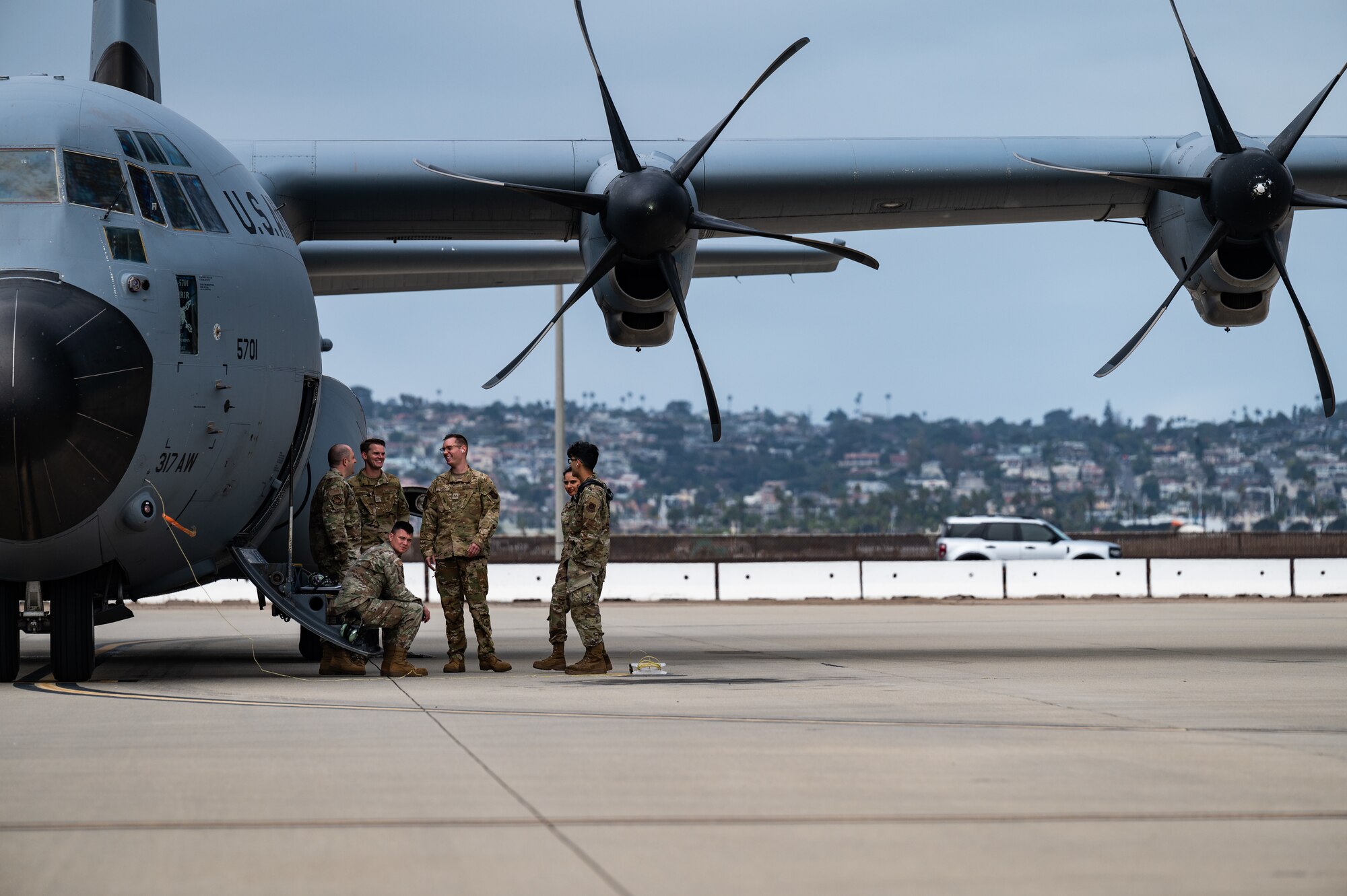 Airmen wait to board a C-130J Hercules
