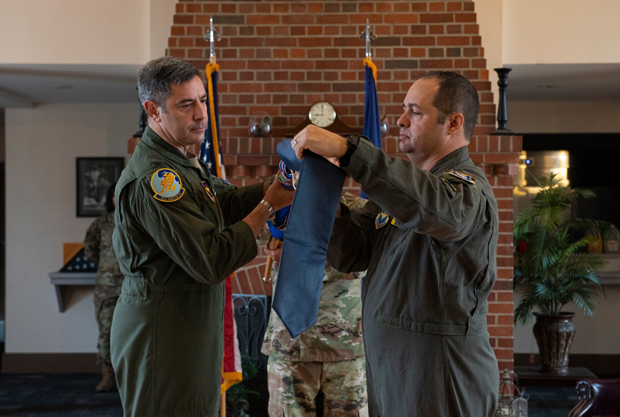 U.S. Air Force Col. Alexander Heyman, left, 14th Operations Group commander, assists Lt. Col. Michael Raabe, 81st Fighter Squadron commander, with furling the squadron's guidon during the 81st FS deactivation ceremony at Moody Air Force Base, Georgia, Dec. 5, 2022. The 81st was a tenant unit at Moody AFB from 2014-2022, originally activated out of Key Field, Mississippi, which loaned out to Air Combat Command’s 23rd Wing. (U.S. Air Force photo by Airman 1st Class Whitney Gillespie)