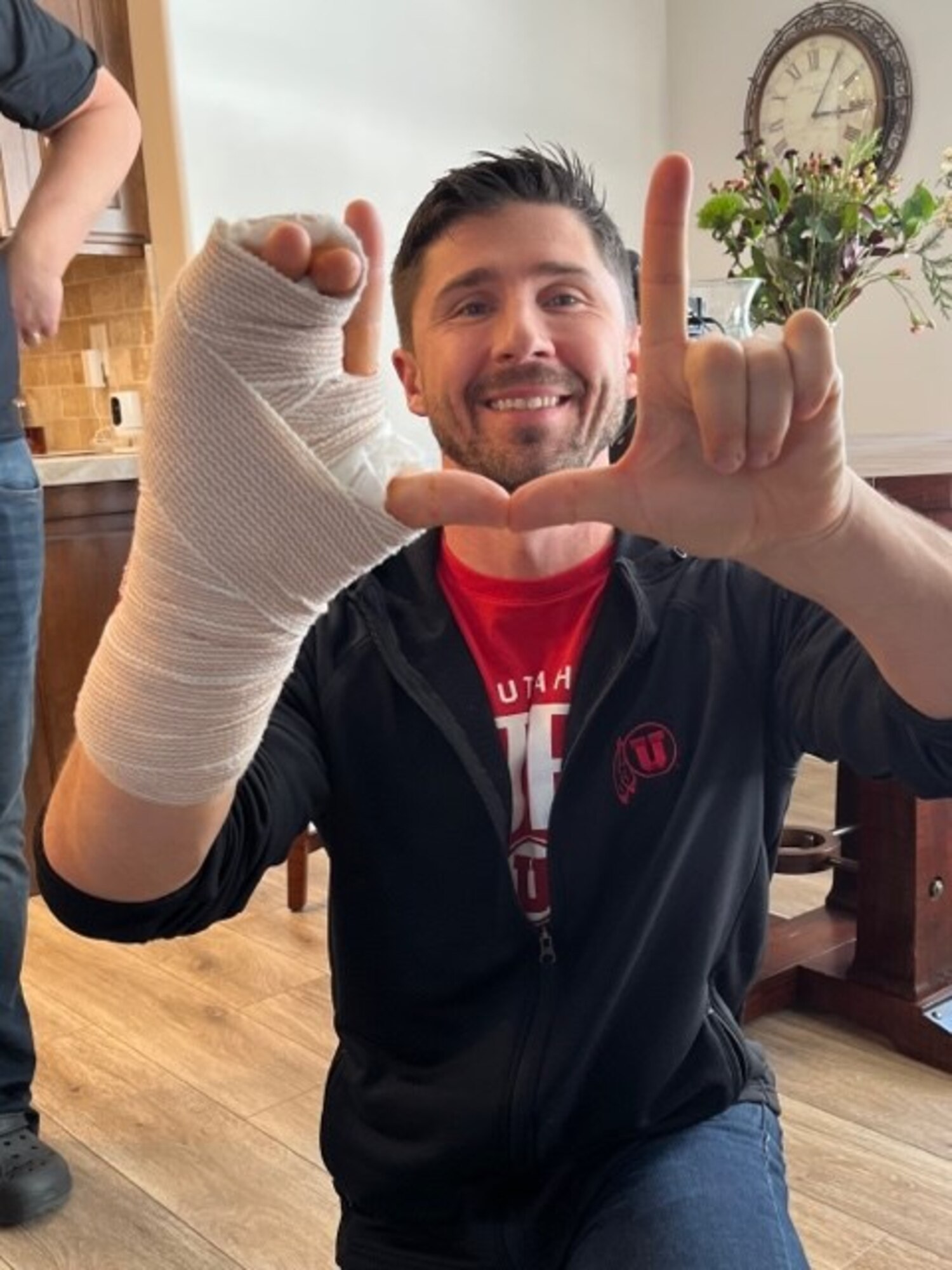 A man with a bandaged hand in a doctor's office