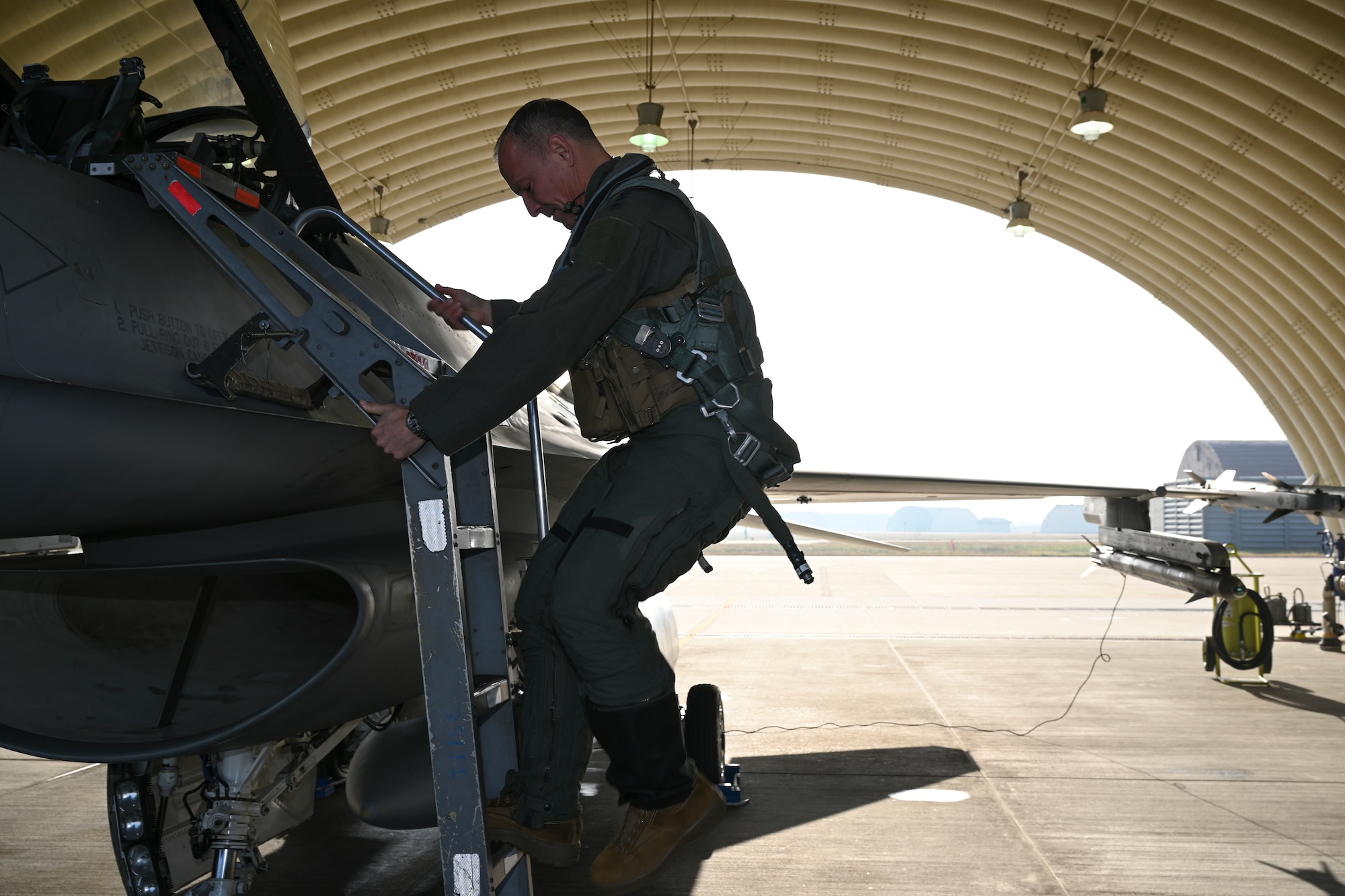 Lt. Gen. Scott L. Pleus, 7th Air Force commander, climbs up an F-16 Fighting Falcon ladder at Kunsan Air Base, Republic of Korea, Dec. 8, 2022. The 7th Air Force’s mission is to organize, train and equip warfighting forces supporting the air component command assigned to the combined forces command and perform missions supporting United Nations Command armistice maintenance. (U.S. Air Force photo by Senior Airman Akeem K. Campbell)