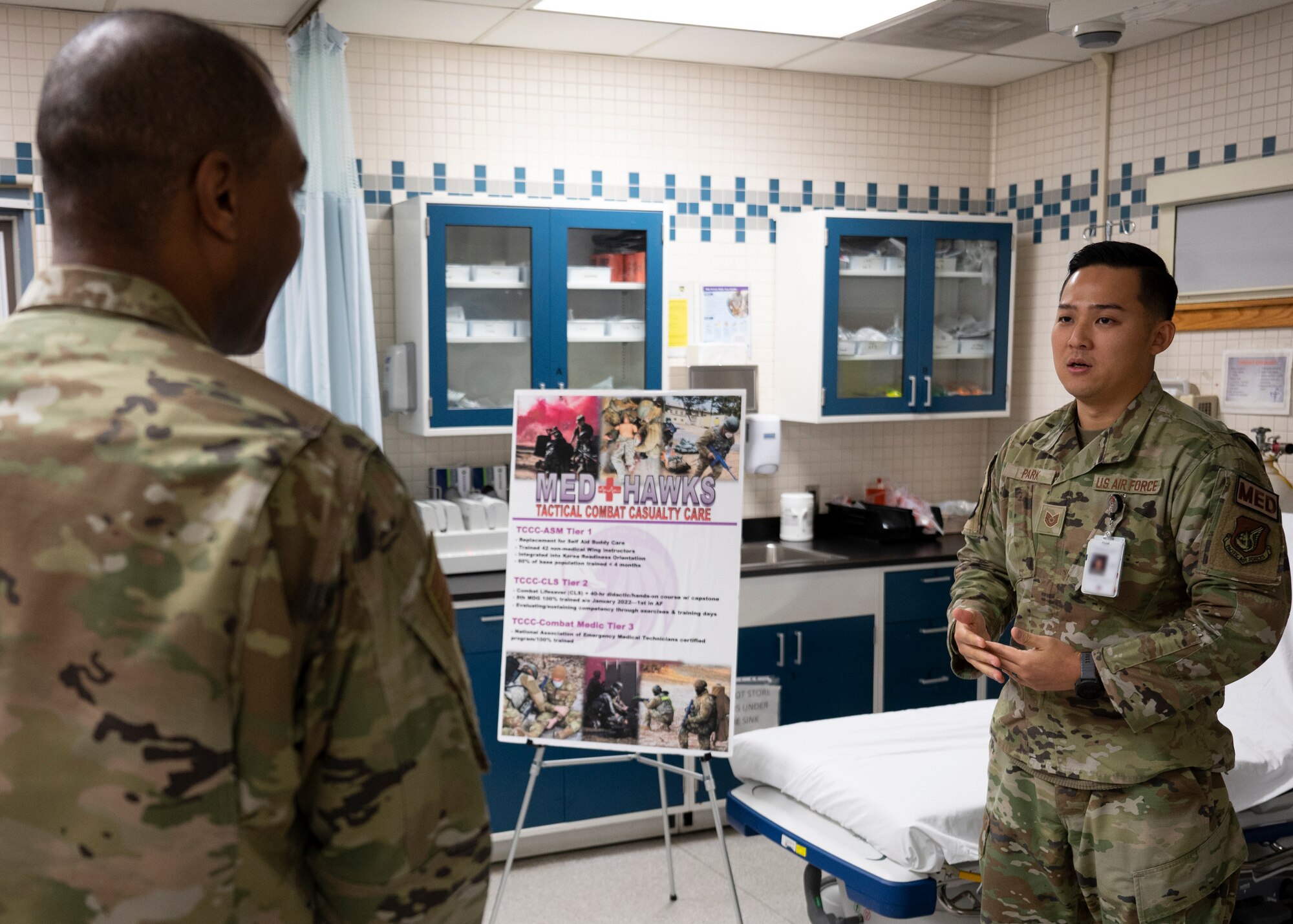 Chief Master Sgt. Alvin R. Dyer, 7th Air Force command chief (left), is briefed by Tech. Sgt. Hee Jin Park, 8th Medical Group group education and training manager, at Kunsan Air Base, Republic of Korea, Dec. 8, 2022. Park regularly conducts tactical combat casualty care training for base personnel. (U.S. Air Force photo by Staff Sgt. Isaiah J. Soliz)