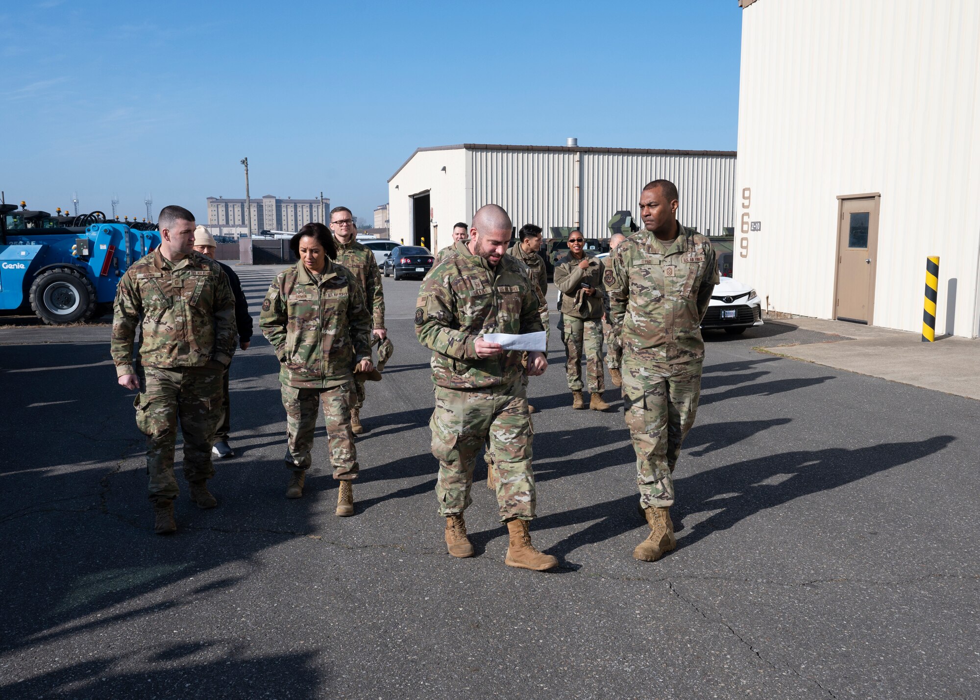 Master Sgt. Kaleb Salazar, 8th Logistics Readiness Squadron war materiel management superintendent (front left), walks with Chief Master Sgt. Alvin R. Dyer, 7th Air Force command chief (front right), during a 7th AF visit to Kunsan Air Base, Republic of Korea, Dec. 8, 2022. During his visit, Salazar briefed Dyer on vehicle fleet statistics, readiness, and future plans. (U.S. Air Force photo by Staff Sgt. Isaiah J. Soliz)