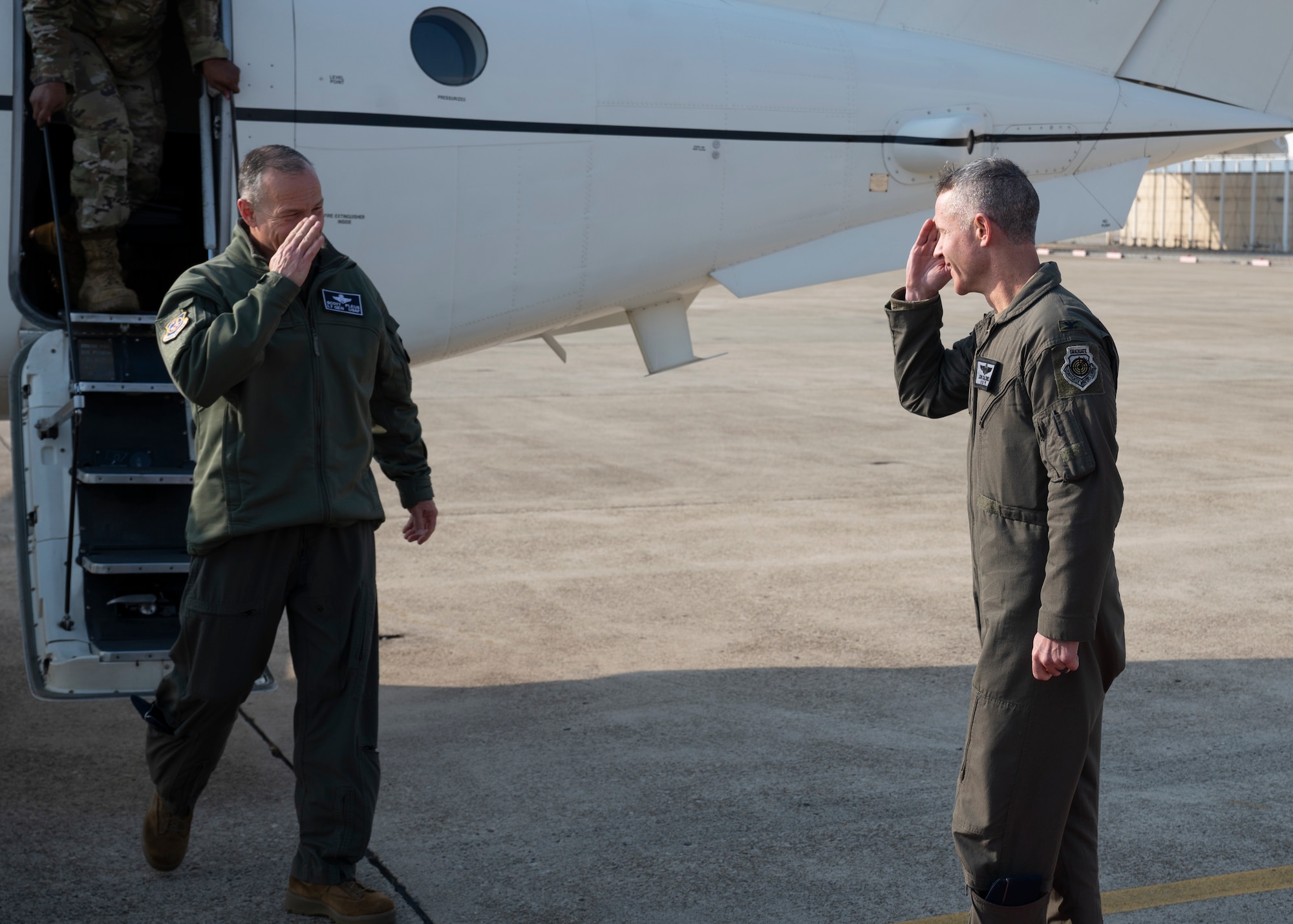 Lt. Gen. Scott L. Pleus, 7th Air Force commander (left), is greeted by Col. John Caldwell, 8th Fighter Wing vice commander, as he arrives at Kunsan Air Base, Republic of Korea, Dec. 7, 2022. Pleus visited the Wolf Pack to speak with Airmen, tour select squadrons and discuss upcoming infrastructure projects with local leadership. (U.S. Air Force photo by Staff Sgt. Isaiah J. Soliz)