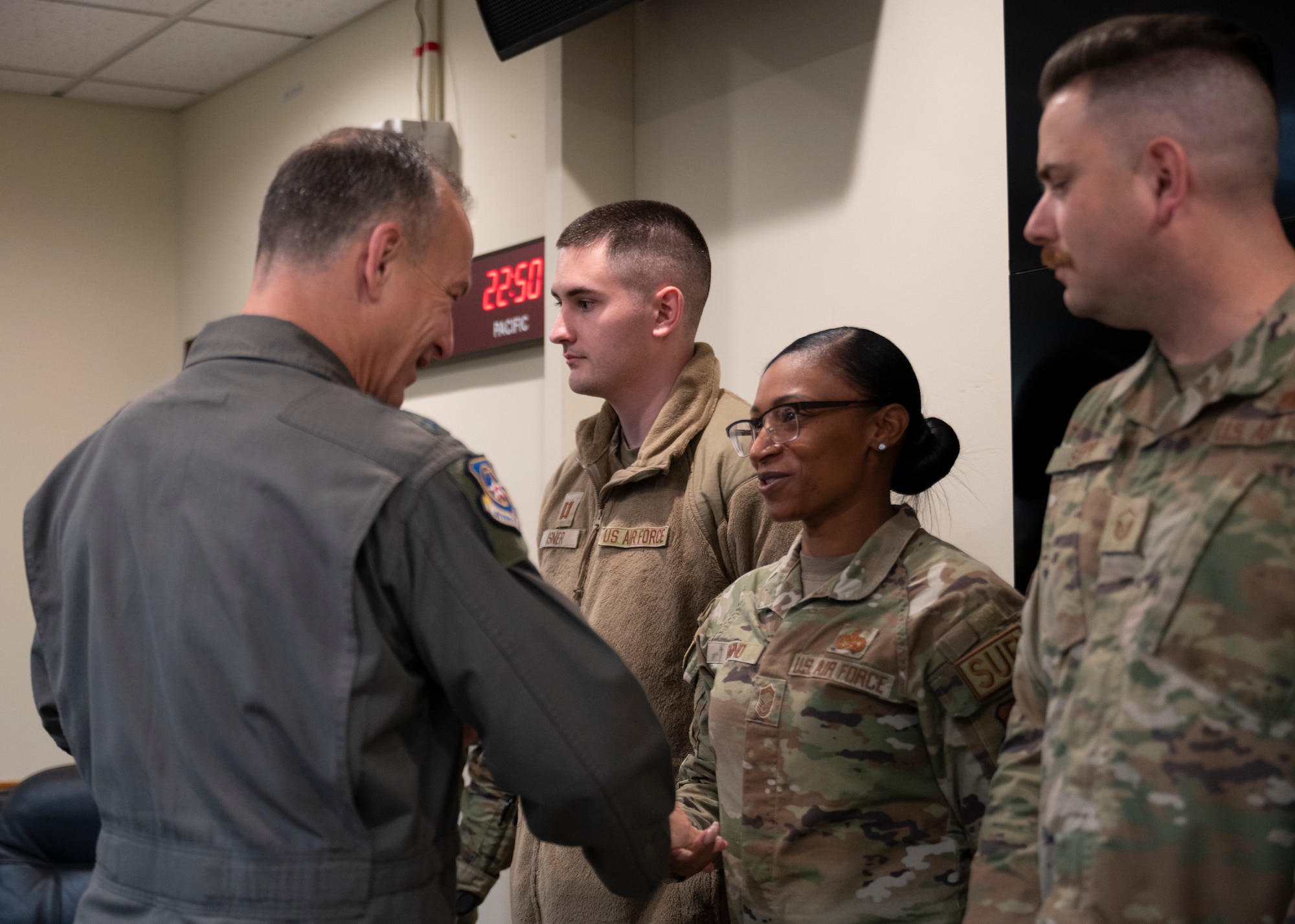 Lt. Gen. Scott L. Pleus, 7th Air Force commander, presents a commander’s coin to Senior Master Sgt. Kellie Babino, 8th Logistics Readiness Squadron materiel management flight chief, at Kunsan Air Base, Republic of Korea, Dec. 7, 2022. Babino was recognized for her outstanding performance as well as her contributions during the 2022 Air Force Ball. (U.S. Air Force photo by Staff Sgt. Isaiah J. Soliz)
