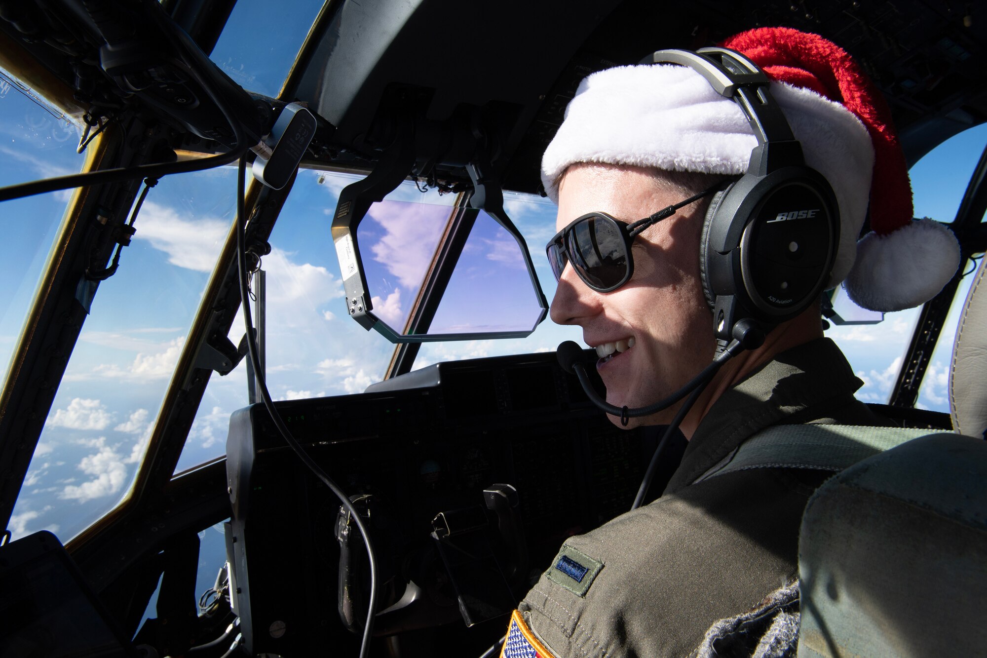 A U.S. Air Force pilot looks out the window of a C-130J Super Hercules