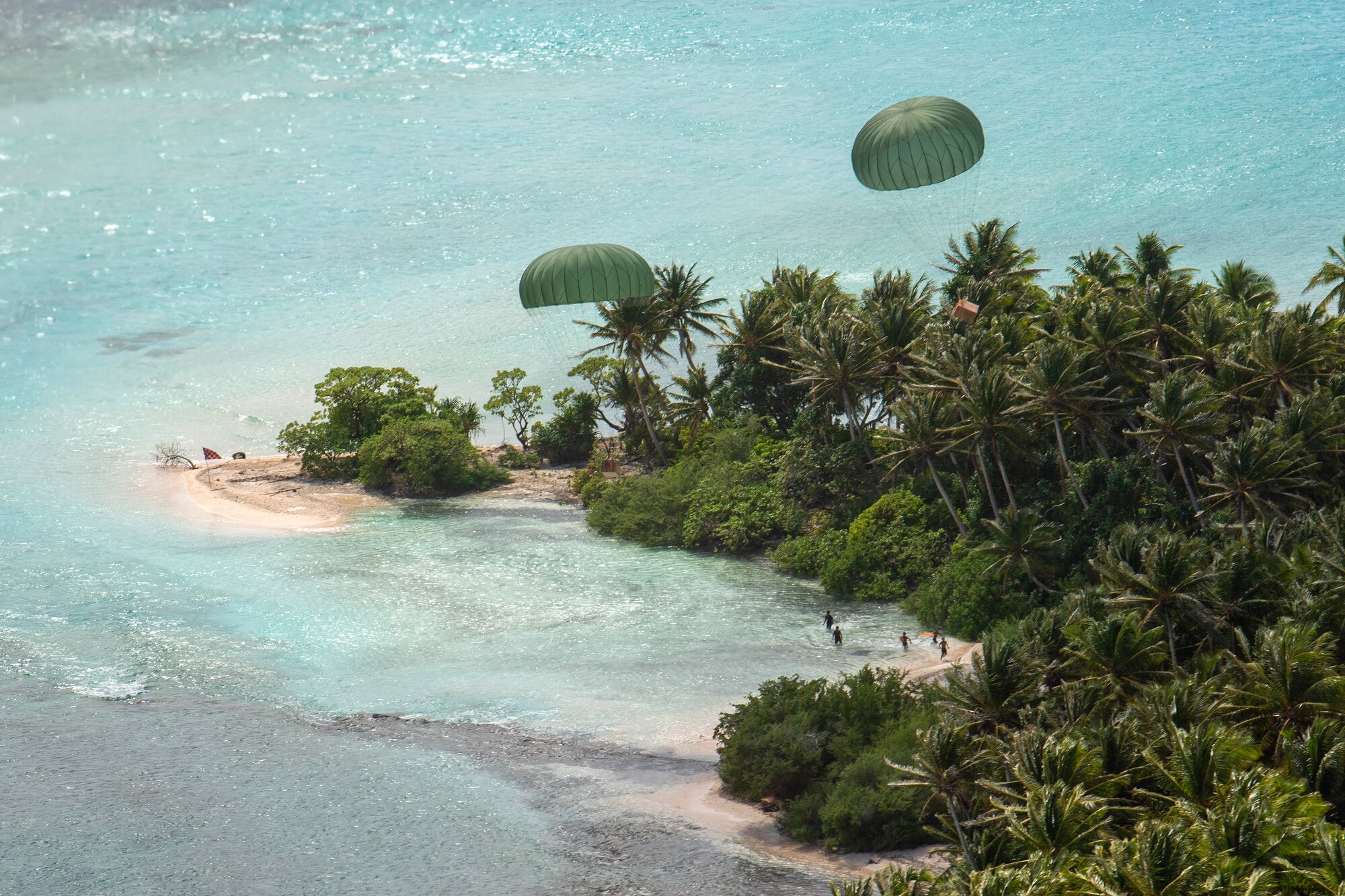 Bundles descend from a Japan Air Self-Defense Force C-130H Hercules