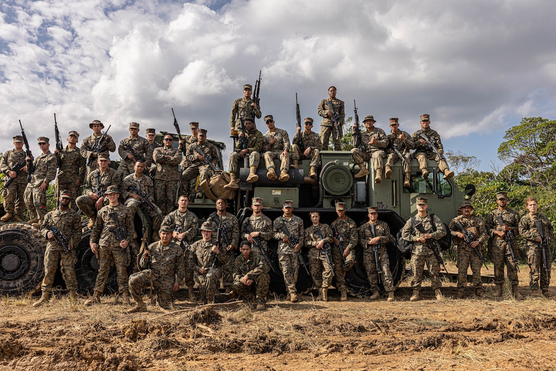U.S. Marines with 3rd Landing Support Battalion, Combat Logistics Regiment 3, 3rd Marine Logistics Group, pose for a group photo during exercise Winter Workhorse, at Central Training Area, Camp Hansen, Okinawa, Japan, Dec. 6, 2022. Winter Workhorse is an annual exercise for CLR-3 to train to carry out mission essential tasks in forward-deployed, austere environments. (U.S. Marine Corps photo by Lance Cpl. Weston Brown)