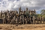 U.S. Marines with 3rd Landing Support Battalion, Combat Logistics Regiment 3, 3rd Marine Logistics Group, pose for a group photo during exercise Winter Workhorse, at Central Training Area, Camp Hansen, Okinawa, Japan, Dec. 6, 2022. Winter Workhorse is an annual exercise for CLR-3 to train to carry out mission essential tasks in forward-deployed, austere environments. (U.S. Marine Corps photo by Lance Cpl. Weston Brown)