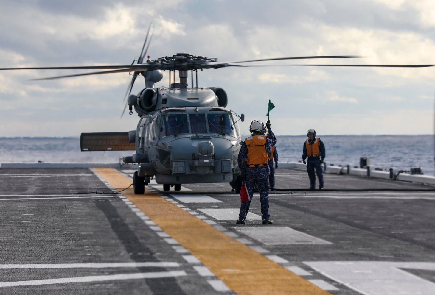 PHILIPPINE SEA (Dec. 6, 2022) Aviation Ordnanceman 2nd Class Elouise Ellis, Aviation Ordnanceman Airman Tymira Holland and Japan Maritime Self-Defense Force (JMSDF) sailors load sonobuoys into an MH-60R Sea Hawk helicopter assigned to the “Warlords” of Helicopter Maritime Strike Squadron (HSM) 51 aboard the multi-purpose destroyer JS Izumo (DDH 183) during a bi-lateral anti-submarine warfare (ASW) exercise, Dec. 6. The U.S. Navy and JMSDF regularly fly, sail and operate together with other Allies and partners to promote security and stability throughout the region. (U.S. Navy photo by Mass Communication Specialist 1st Class Deanna C. Gonzales)