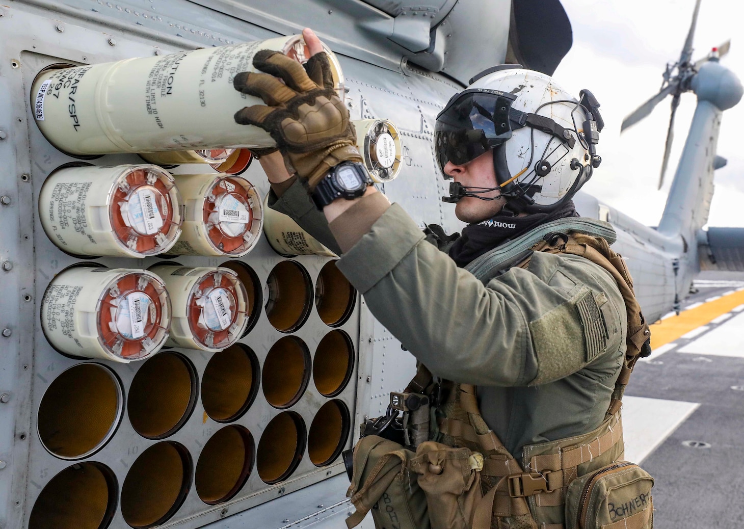 PHILIPPINE SEA (Dec. 6, 2022) Naval Air Crewman (Helicopter) 2nd Class Maxwell Bohnert inspects sonobuoys loaded into an MH-60R Sea Hawk helicopter assigned to the “Warlords” of Helicopter Maritime Strike Squadron (HSM) 51 aboard the Japan Maritime Self-Defense Force (JMSDF) multi-purpose destroyer JS Izumo (DDH 183) during a bi-lateral anti-submarine warfare (ASW) exercise, Dec. 6. The U.S. Navy and JMSDF regularly fly, sail and operate together with other Allies and partners to promote security and stability throughout the region. (U.S. Navy photo by Mass Communication Specialist 1st Class Deanna C. Gonzales)