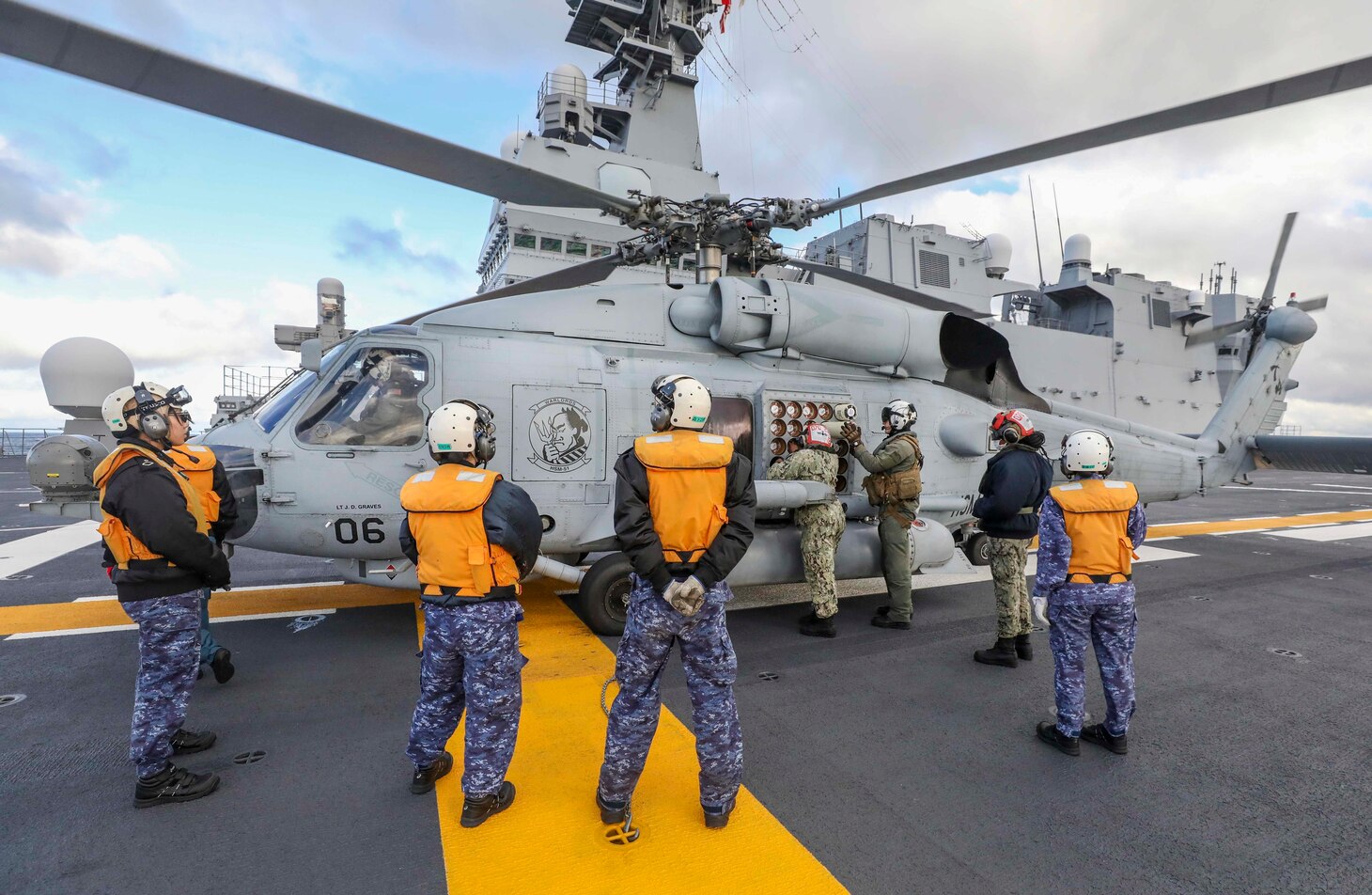 PHILIPPINE SEA (Dec. 6, 2022) Naval Air Crewman (Helicopter) 2nd Class Maxwell Bohnert and Aviation Ordnanceman 2nd Class Elouise Ellis, load and inspect sonobuoys in an MH-60R Sea Hawk helicopter assigned to the “Warlords” of Helicopter Maritime Strike Squadron (HSM) 51 aboard the Japan Maritime Self-Defense Force (JMSDF) multi-purpose destroyer JS Izumo (DDH 183) during a bi-lateral anti-submarine warfare (ASW) exercise, Dec. 6. The U.S. Navy and JMSDF regularly fly, sail and operate together with other Allies and partners to promote security and stability throughout the region. (U.S. Navy photo by Mass Communication Specialist 1st Class Deanna C. Gonzales)