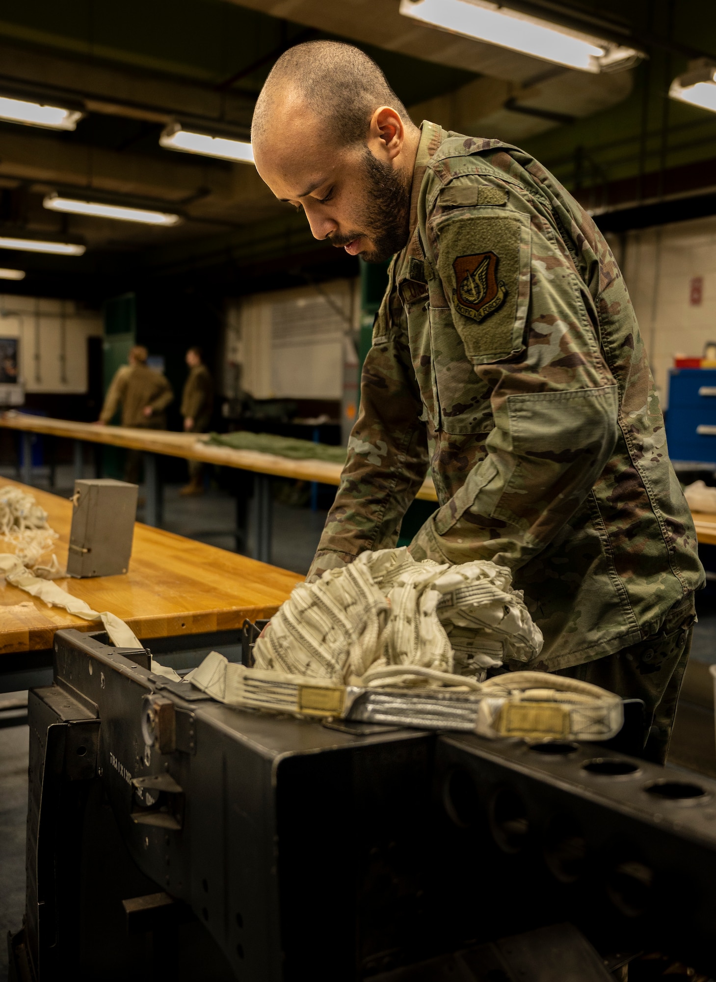 U.S. Air Force Senior Airman James Hunter, 51st Operations Support Squadron aircrew flight equipment technician, practices packing a drogue parachute into an F-16 Fighting Falcon ejection seat during training at Osan Air Base, Republic of Korea, Dec. 7, 2022.